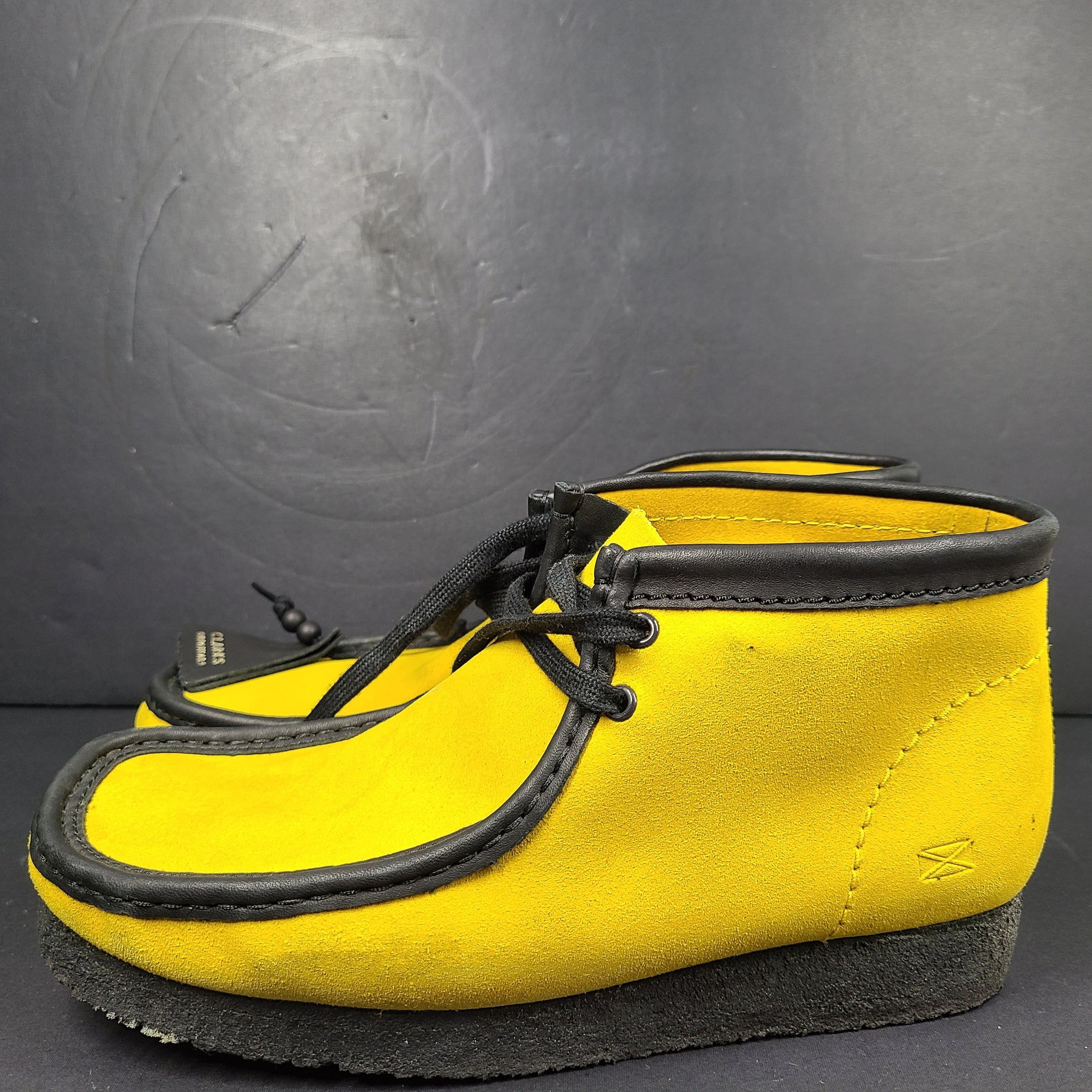 A pair of vibrant yellow Clarks Originals Jamaica Bee shoes.
