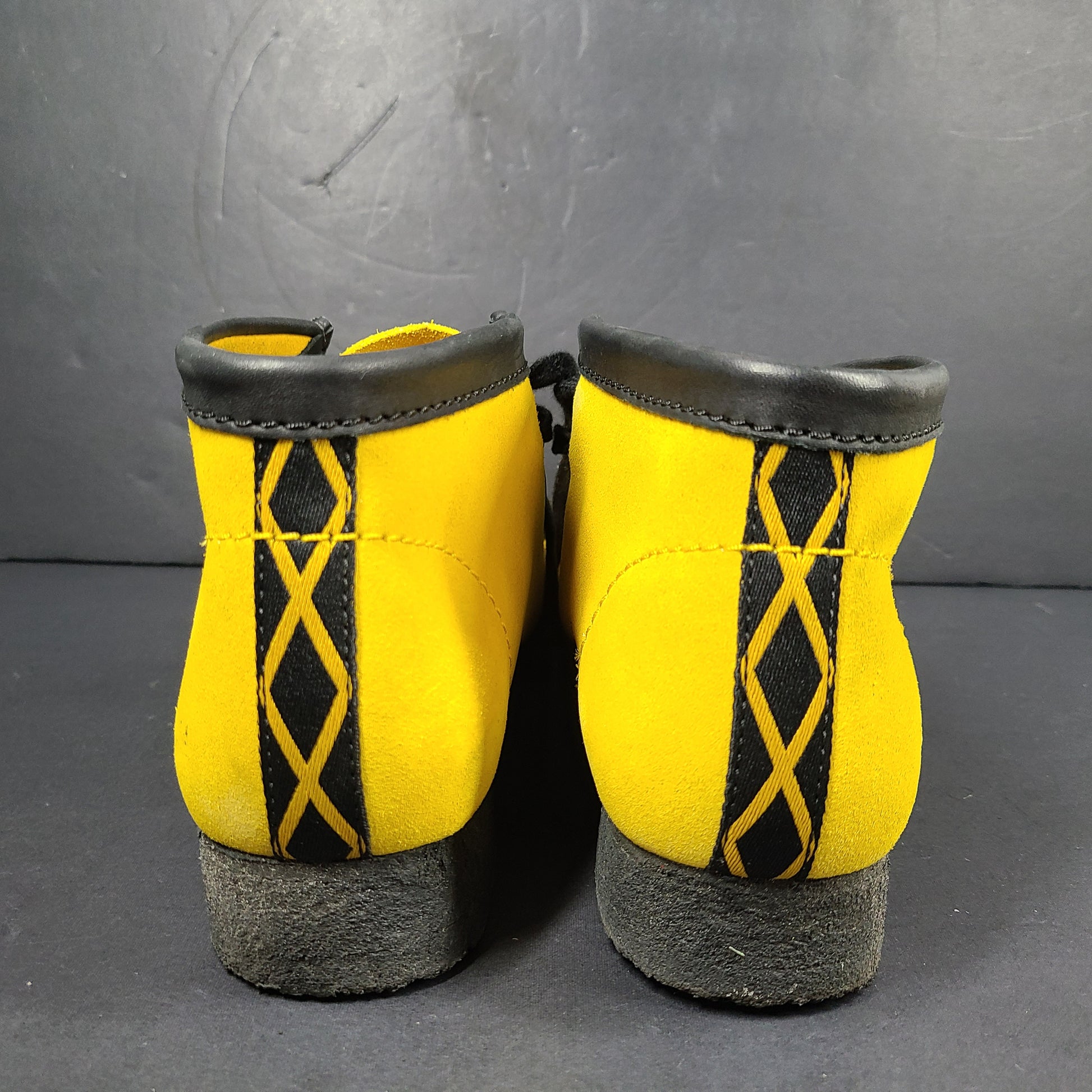 A pair of vibrant yellow Clarks Originals Jamaica Bee shoes.