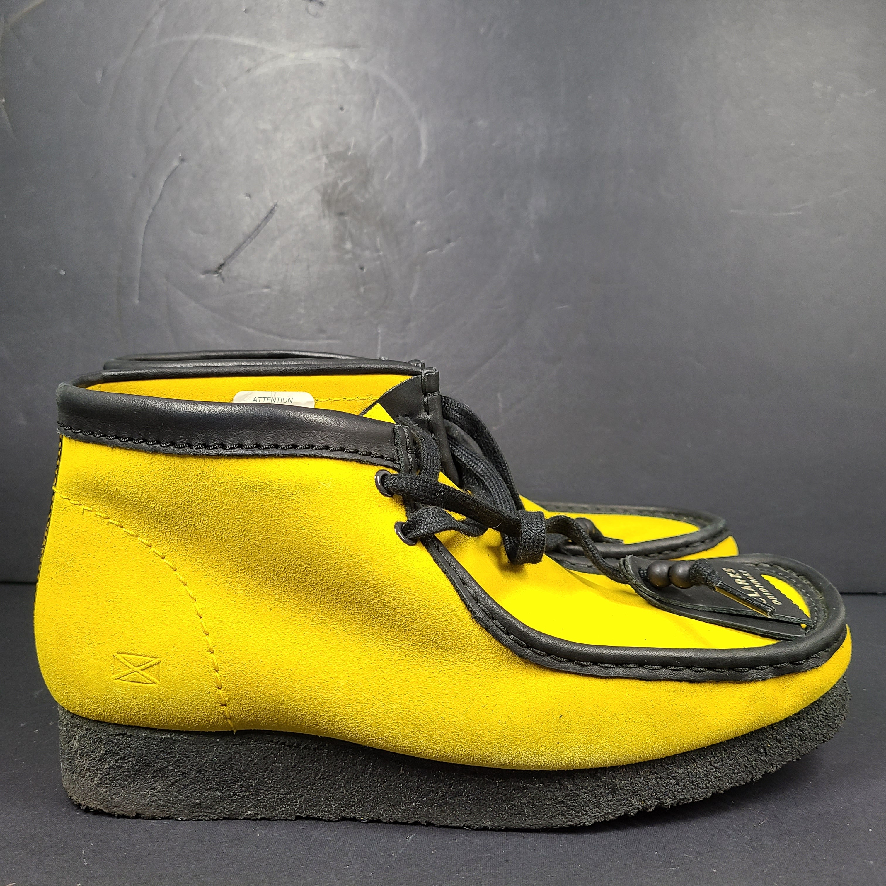 A pair of vibrant yellow Clarks Originals Jamaica Bee shoes.