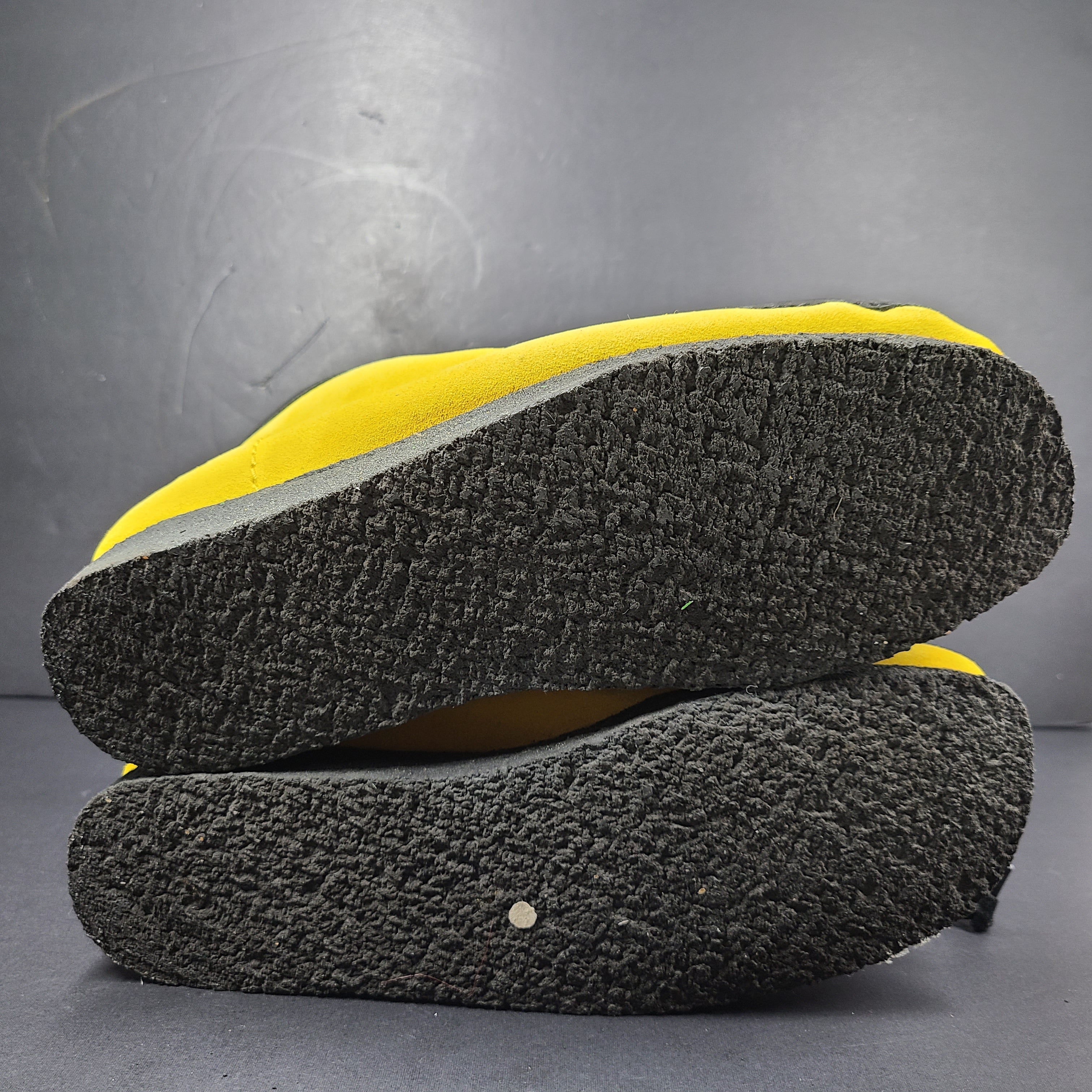 A pair of vibrant yellow Clarks Originals Jamaica Bee shoes.