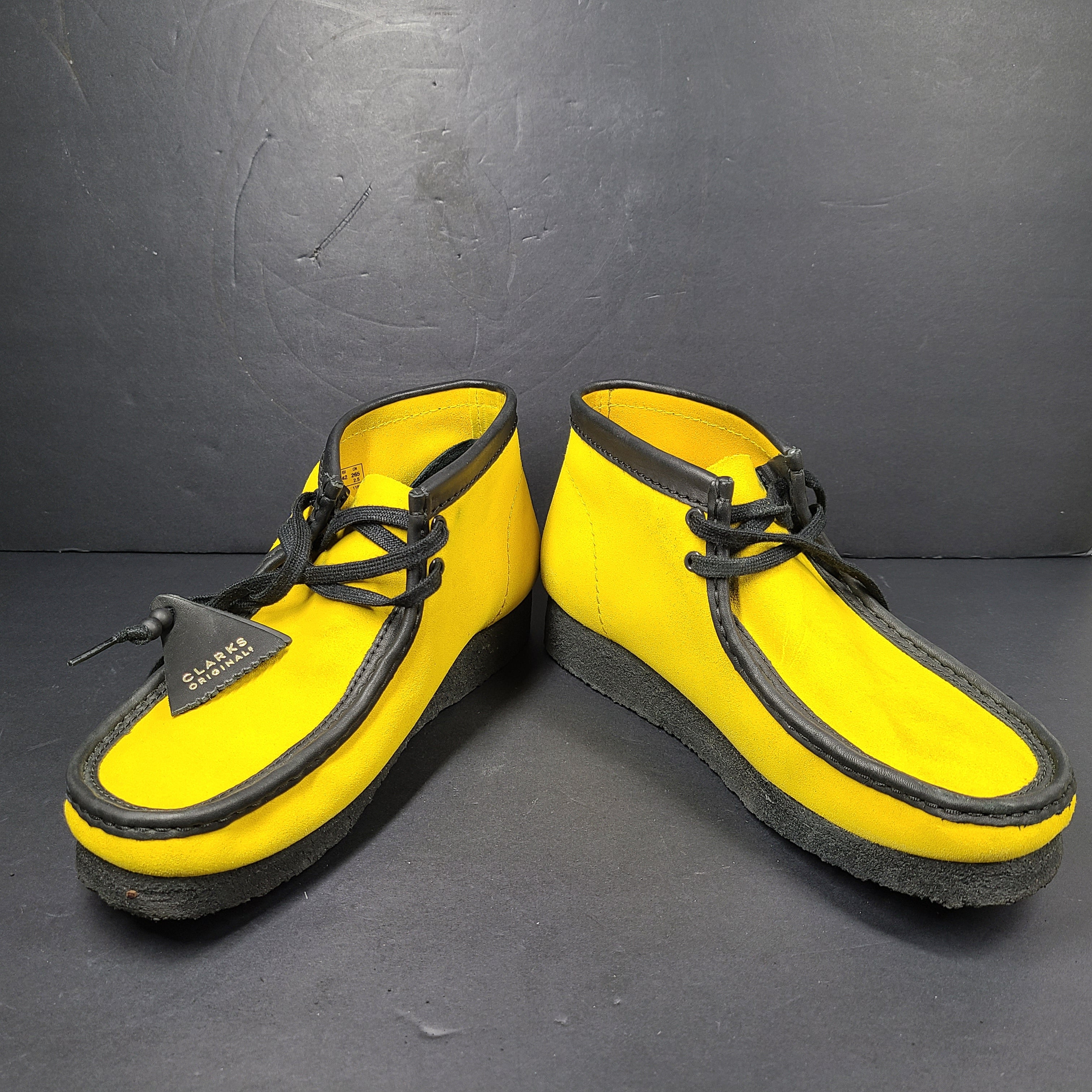 A pair of vibrant yellow Clarks Originals Jamaica Bee shoes.