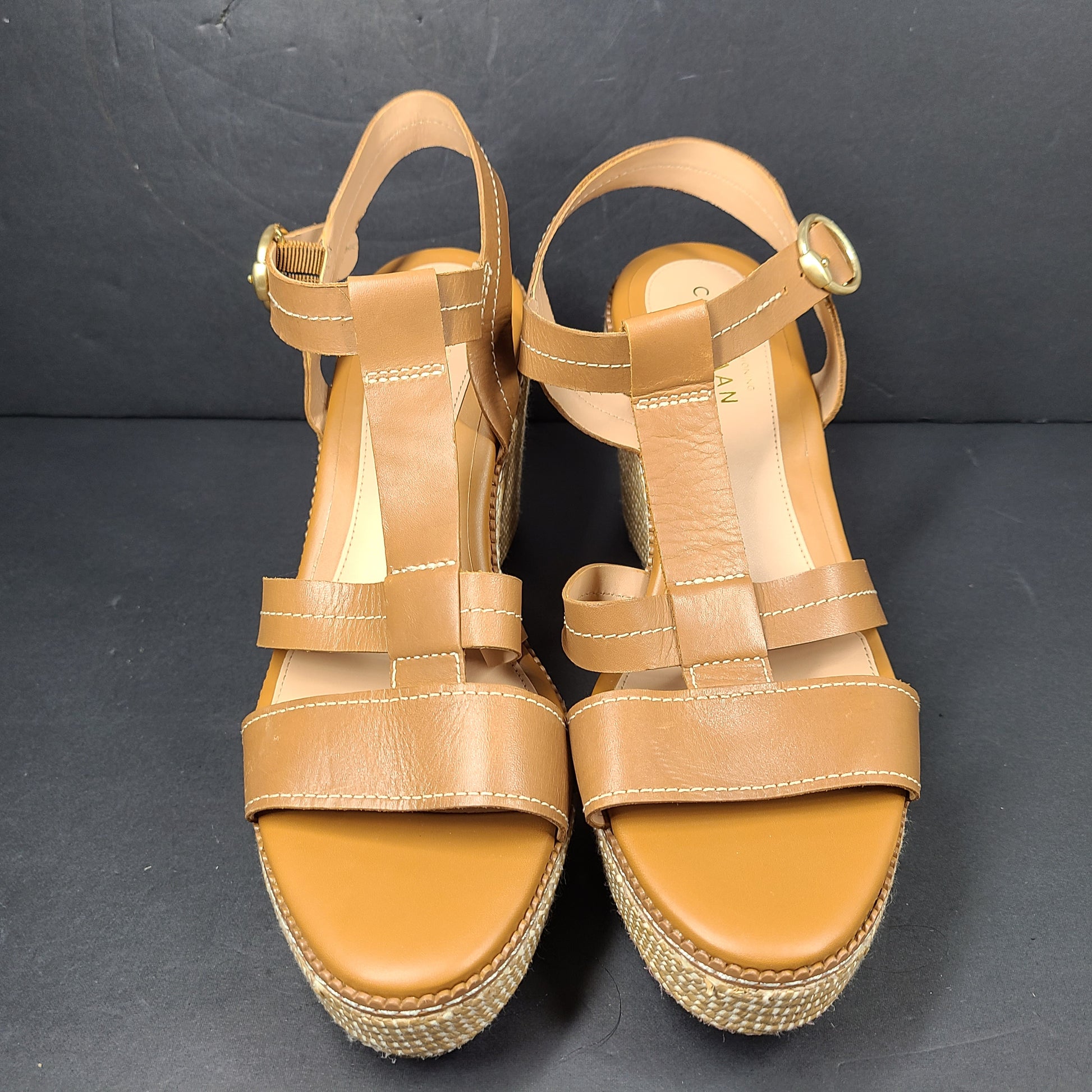A pair of tan Cole Haan Cloudfeel Grandseries wedge sandals for women