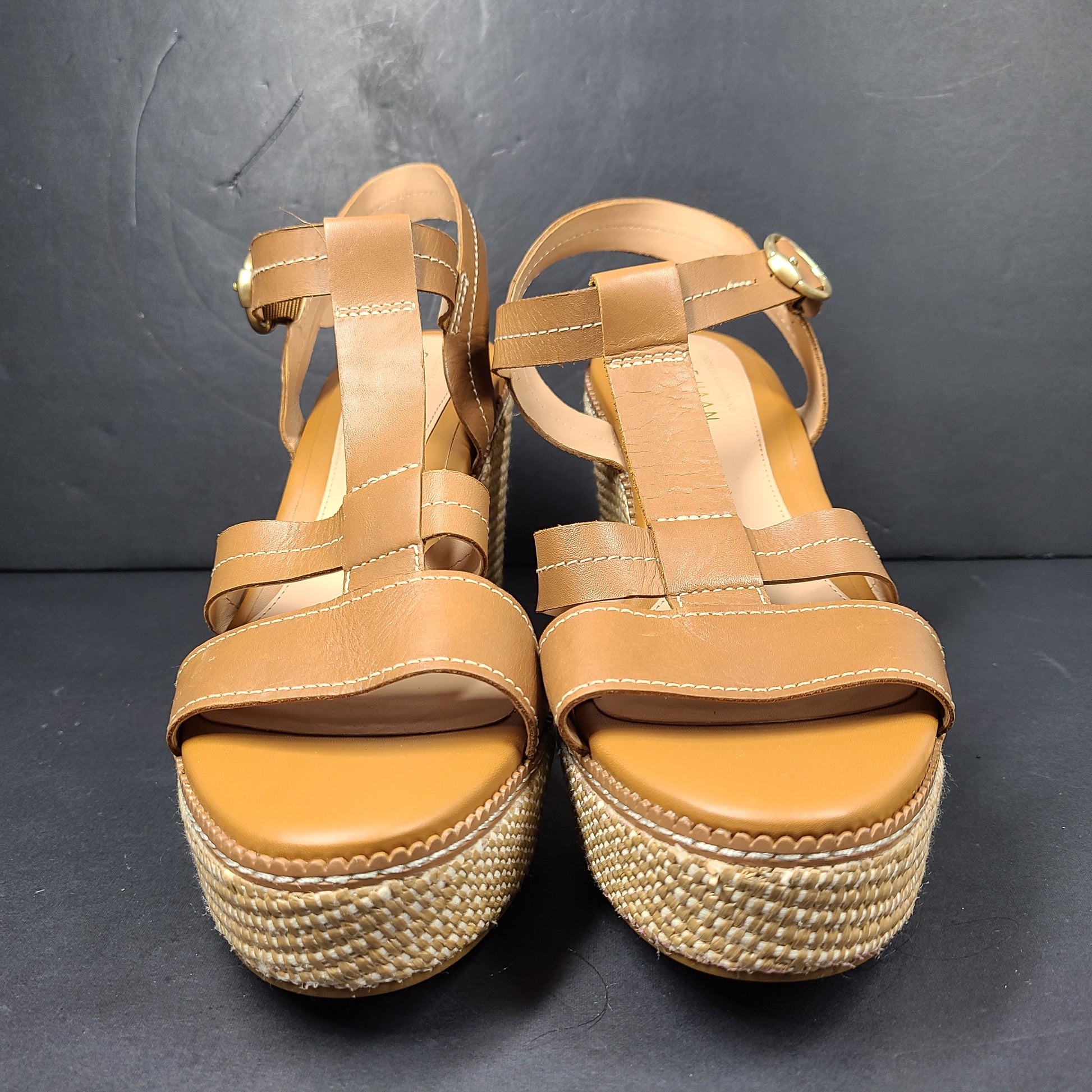 A pair of tan Cole Haan Cloudfeel Grandseries wedge sandals for women