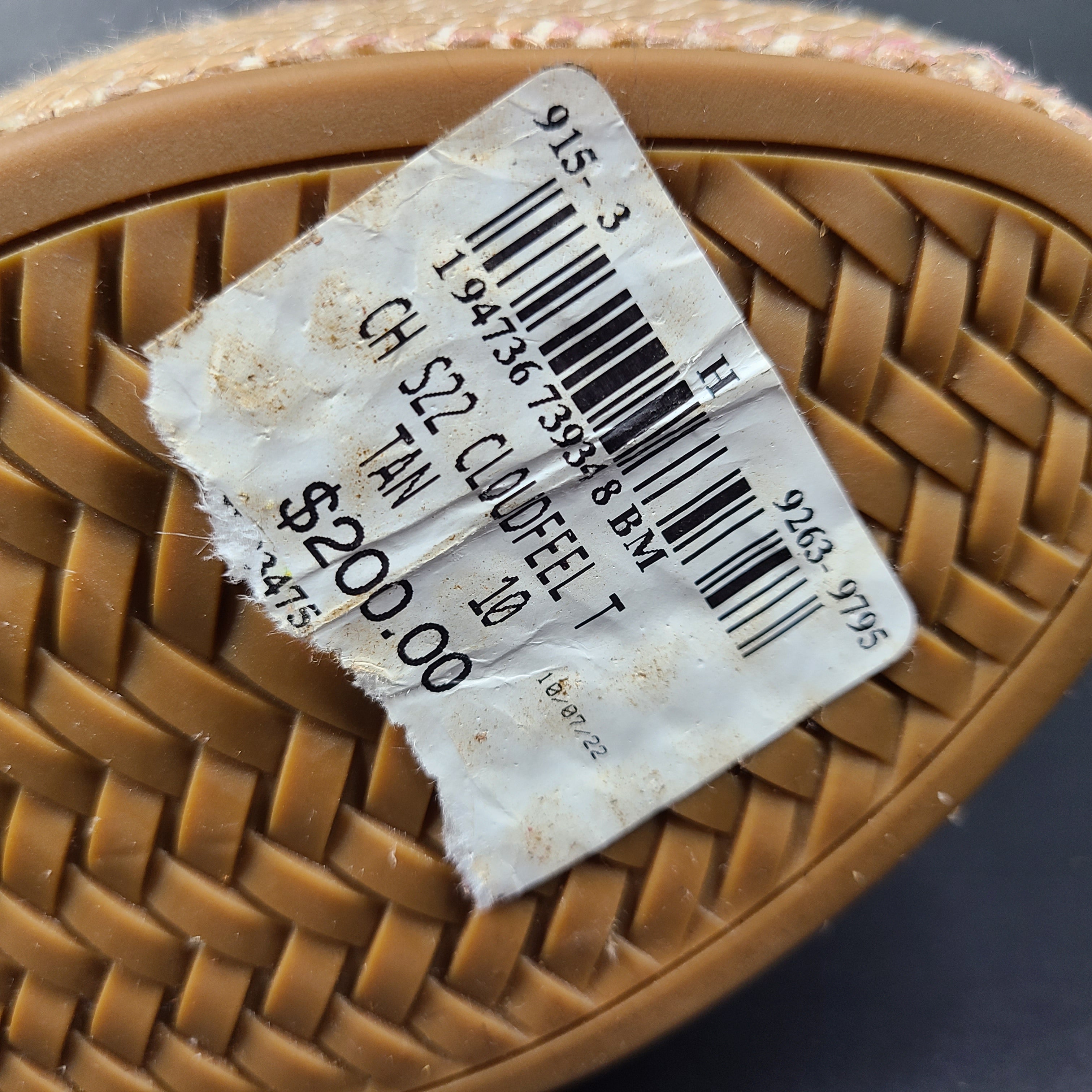 A pair of tan Cole Haan Cloudfeel Grandseries wedge sandals for women