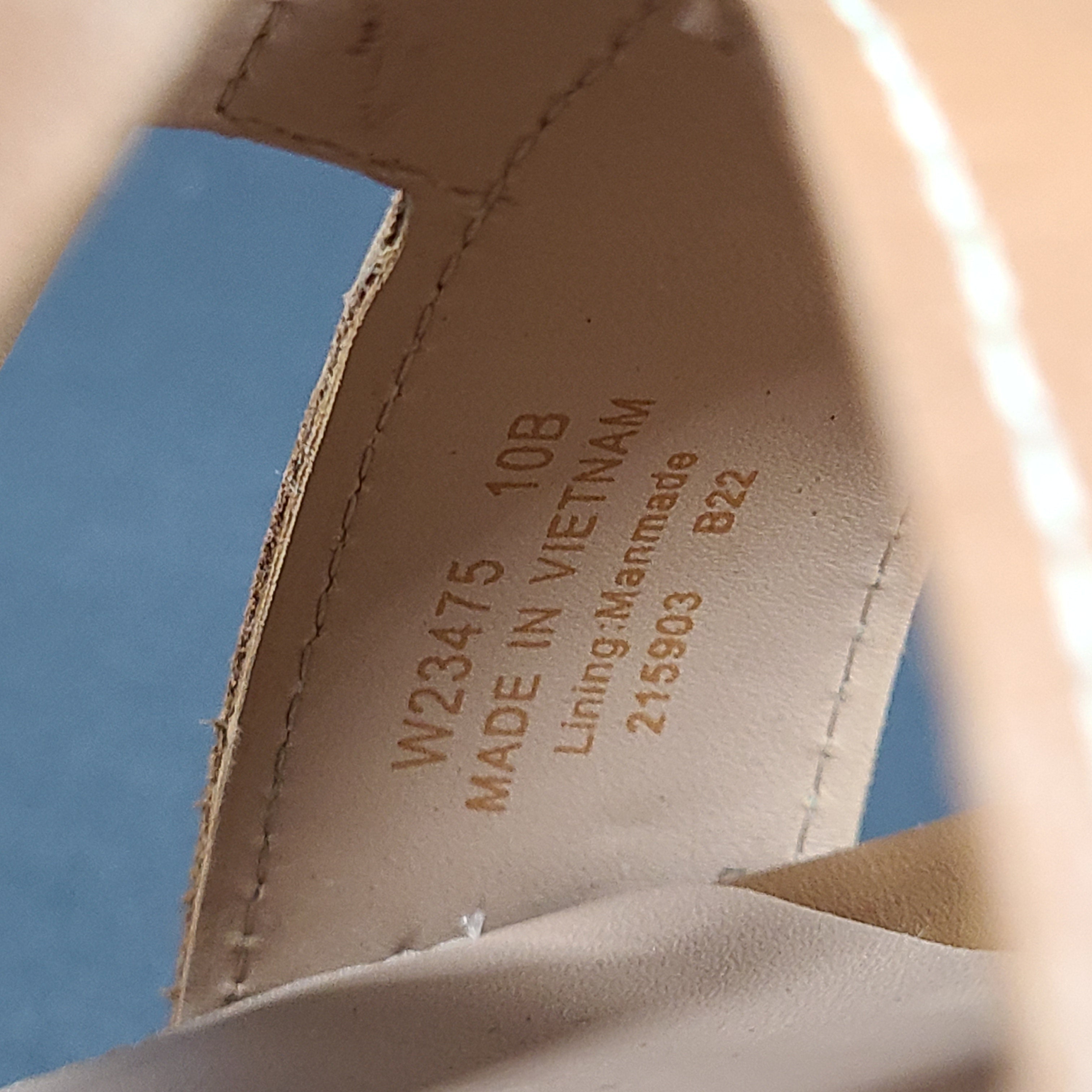 A pair of tan Cole Haan Cloudfeel Grandseries wedge sandals for women
