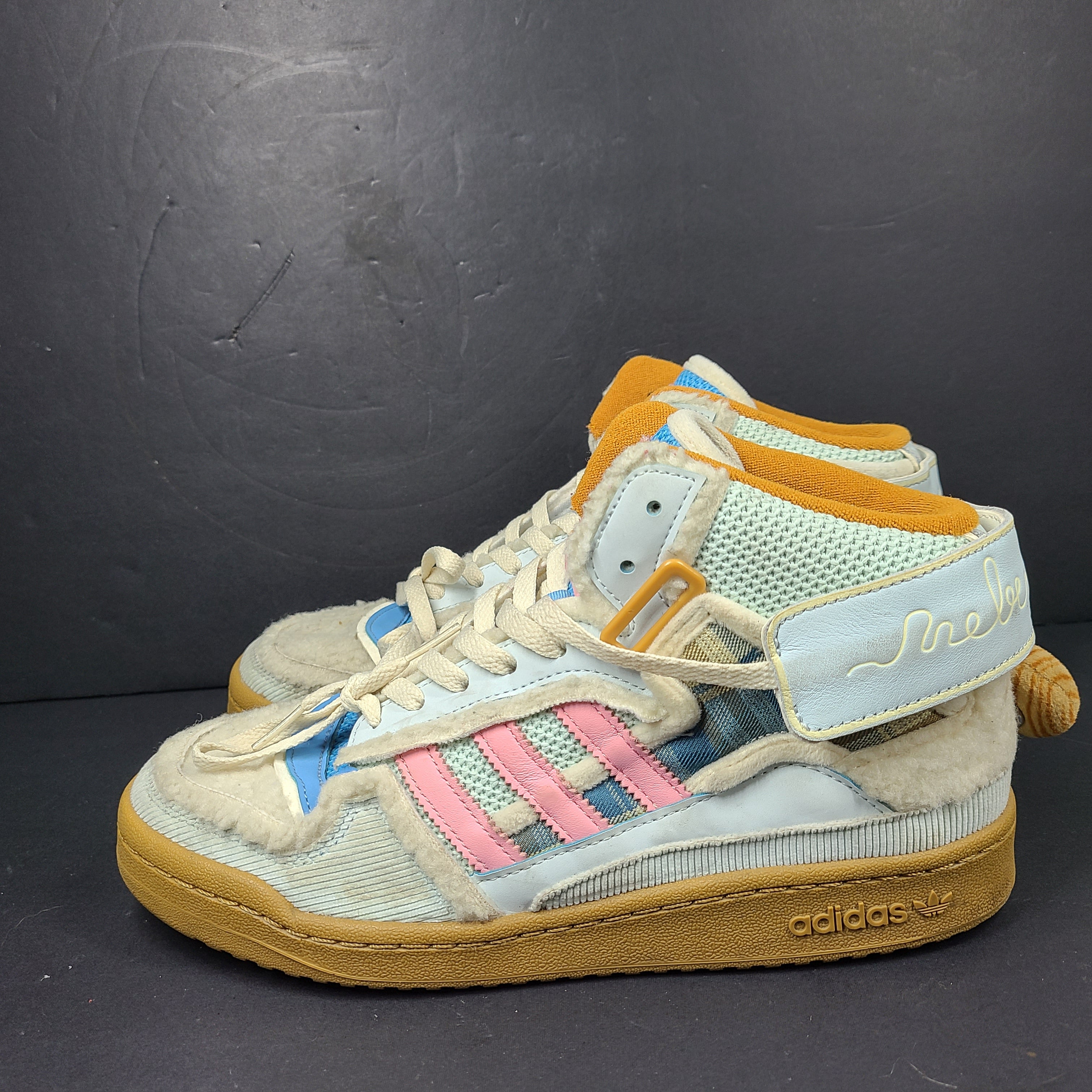 A pair of multicolor Adidas sneakers with artistic design