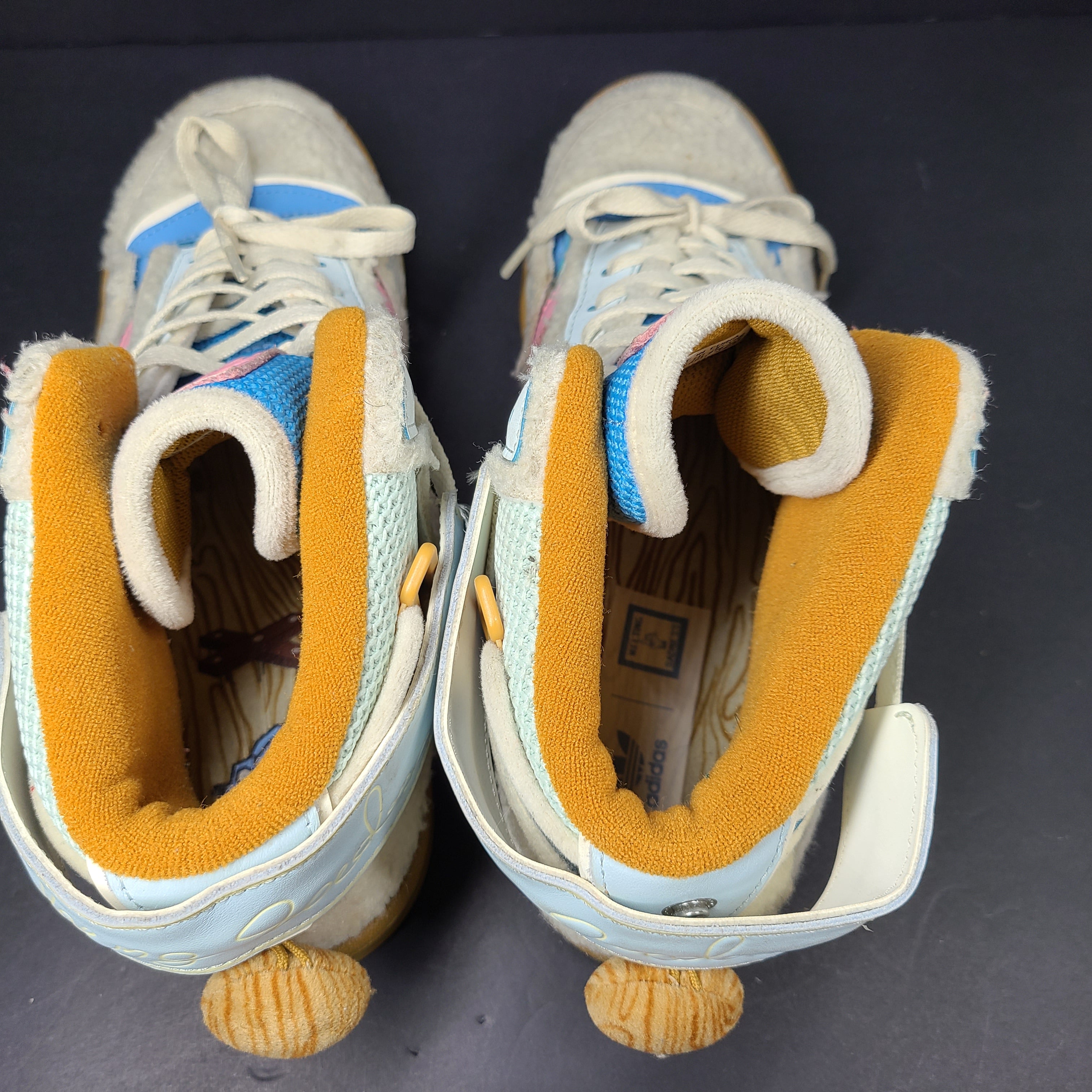 A pair of multicolor Adidas sneakers with artistic design