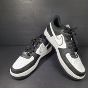 A stylish pair of Nike Air Force 1 Low sneakers in black and white.