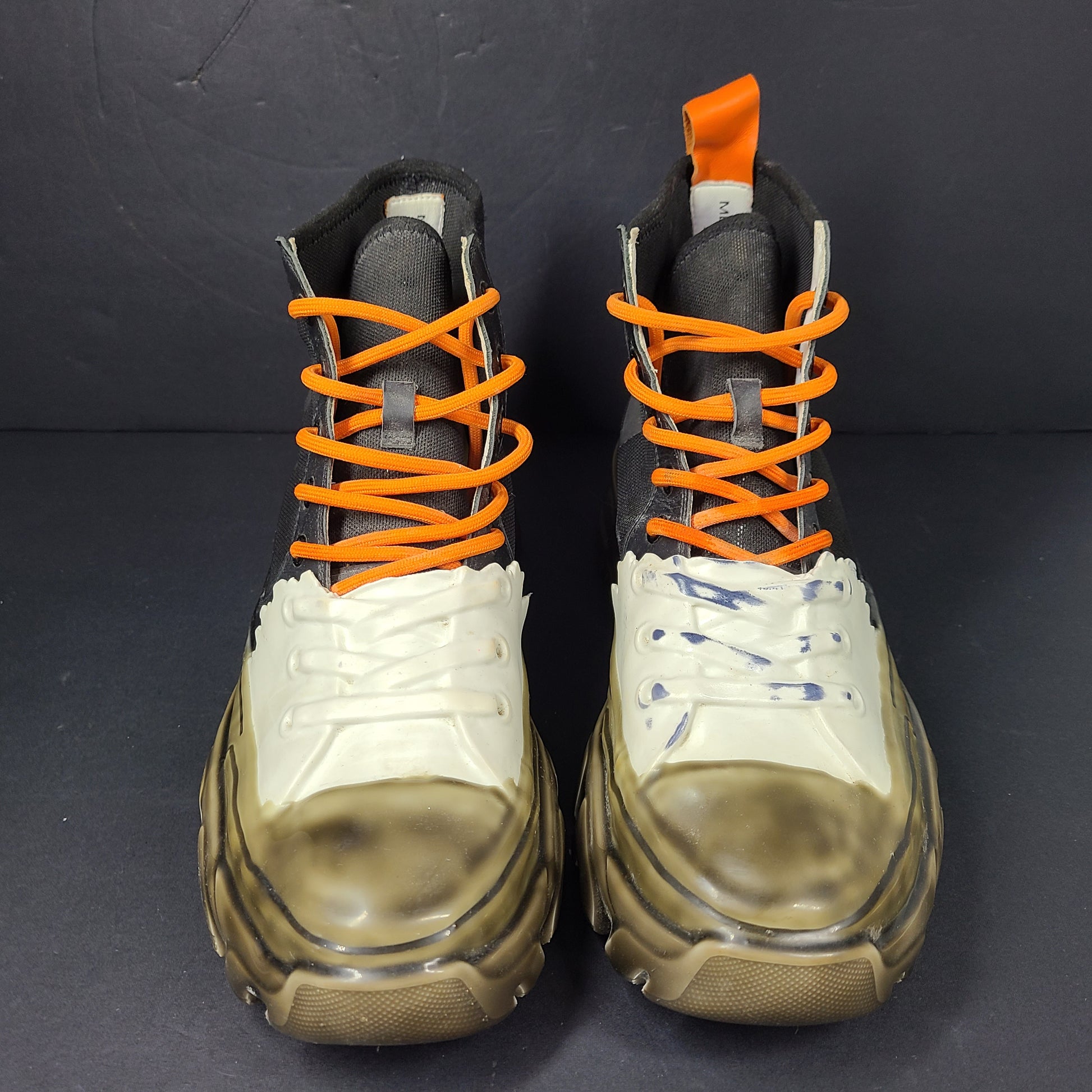 A pair of black and orange high top sneakers with Sz 41 for men.