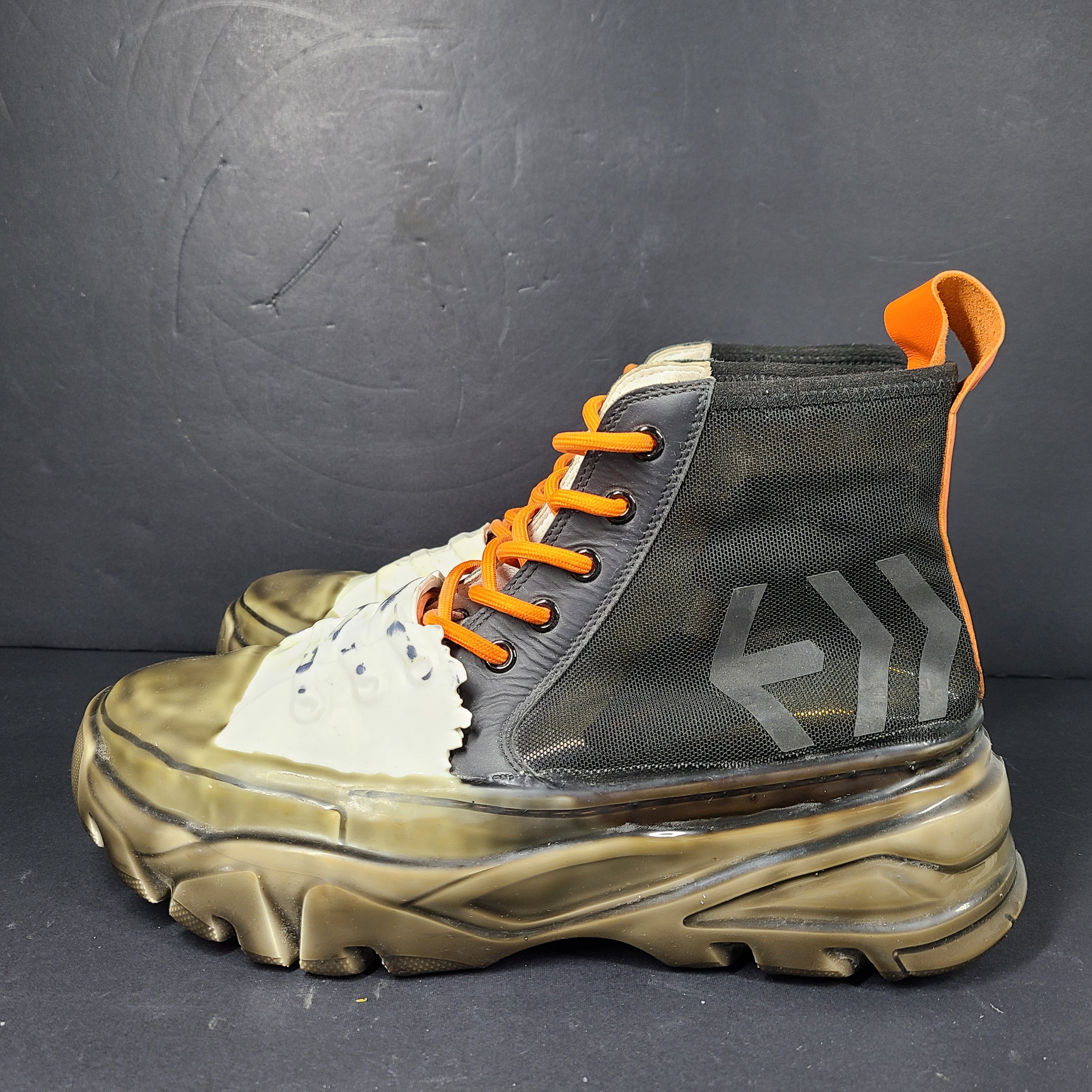 A pair of black and orange high top sneakers with Sz 41 for men.
