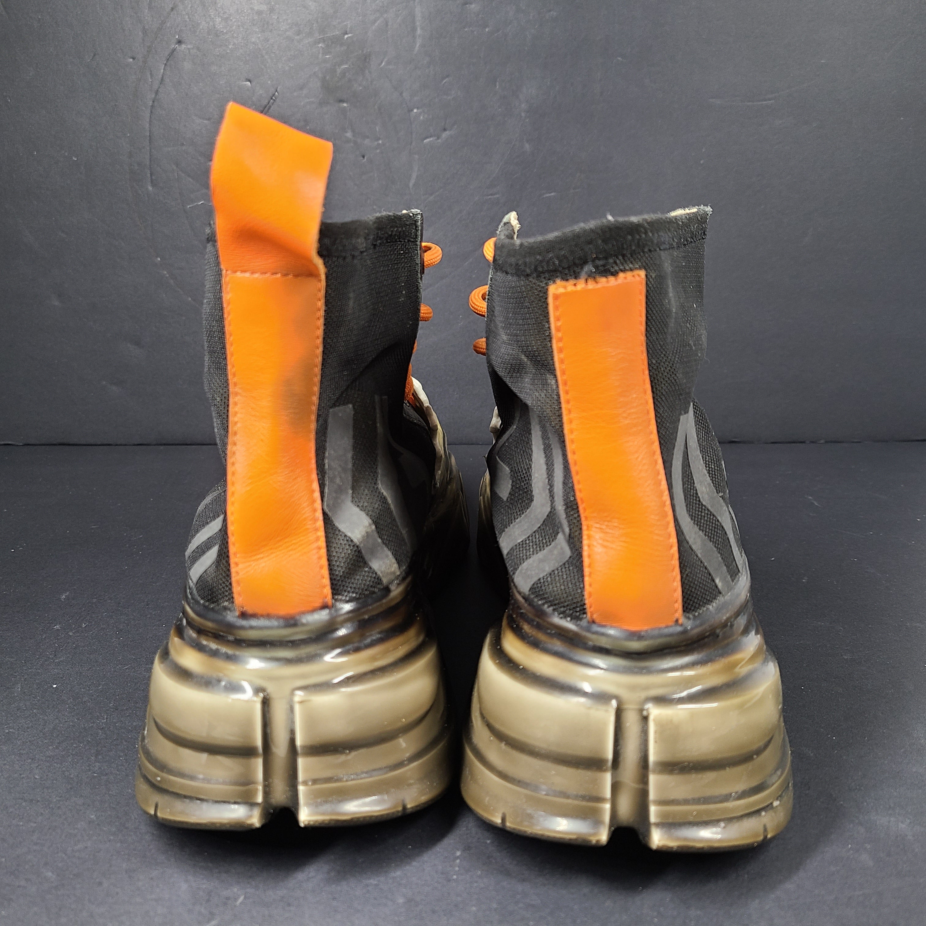 A pair of black and orange high top sneakers with Sz 41 for men.