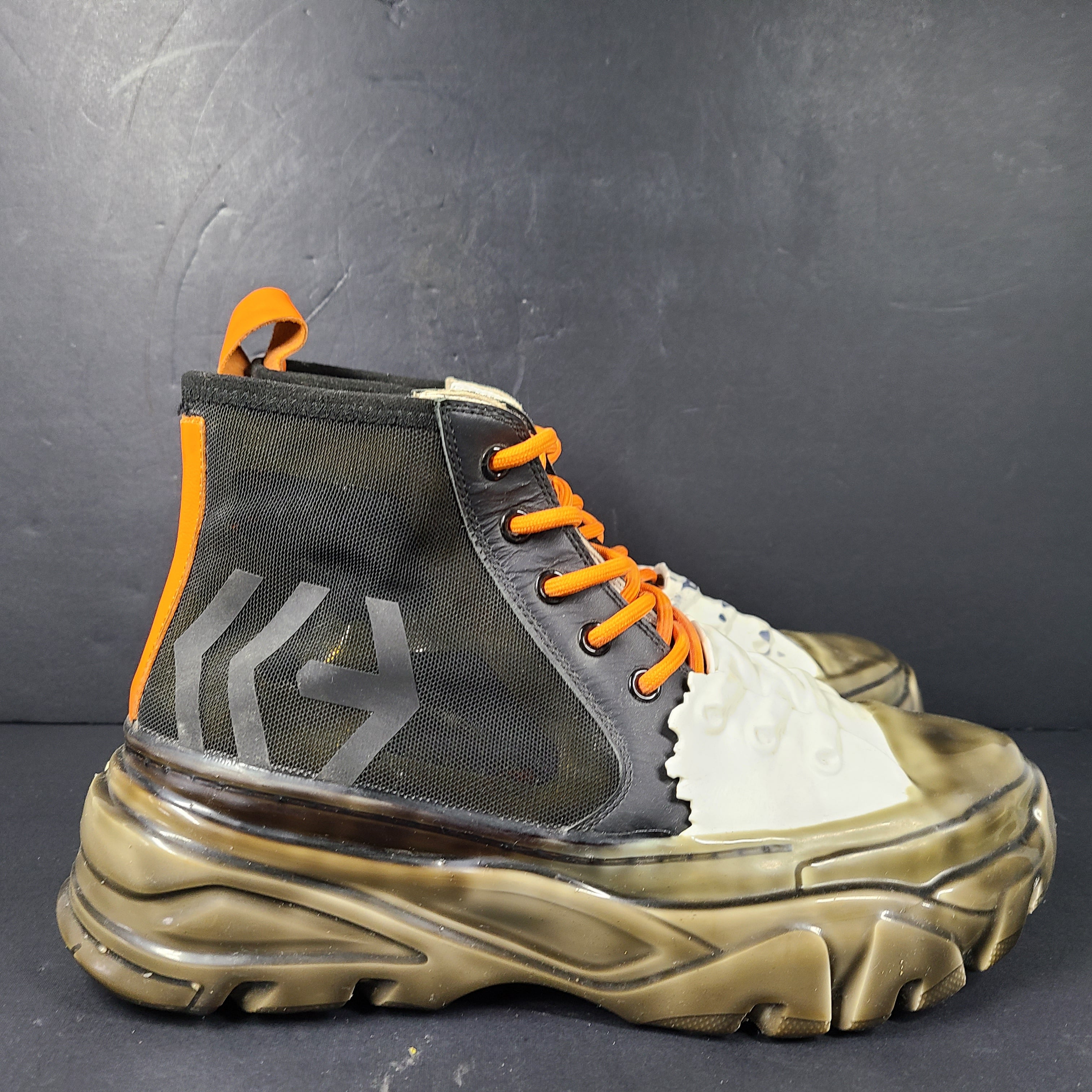 A pair of black and orange high top sneakers with Sz 41 for men.