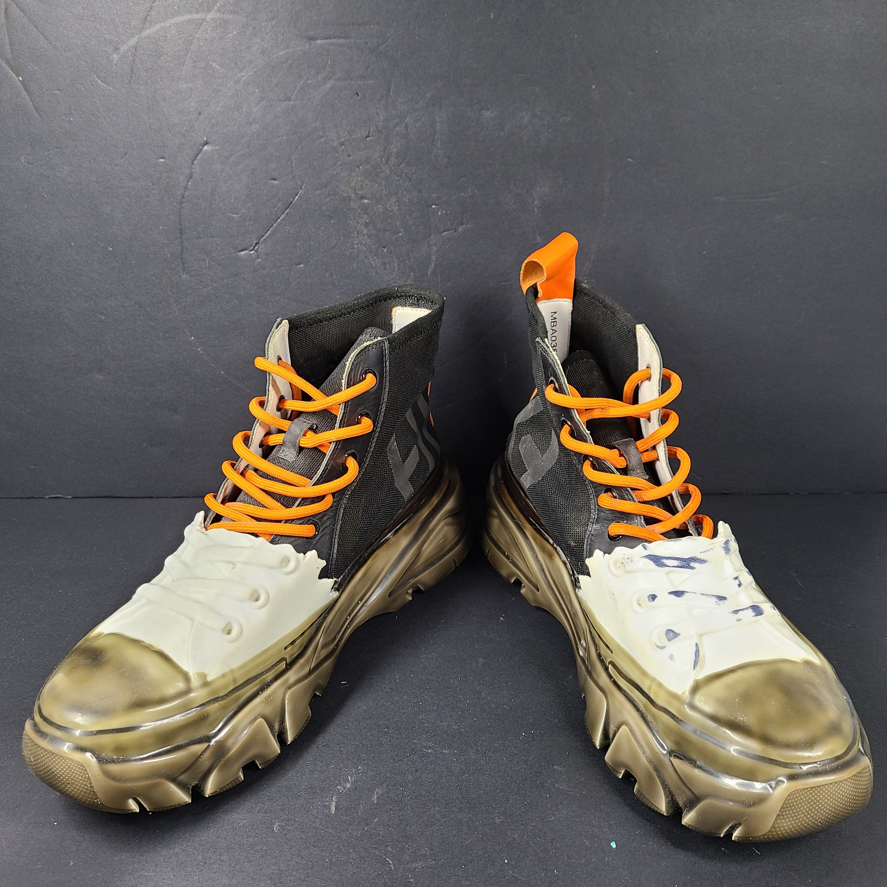 A pair of black and orange high top sneakers with Sz 41 for men.