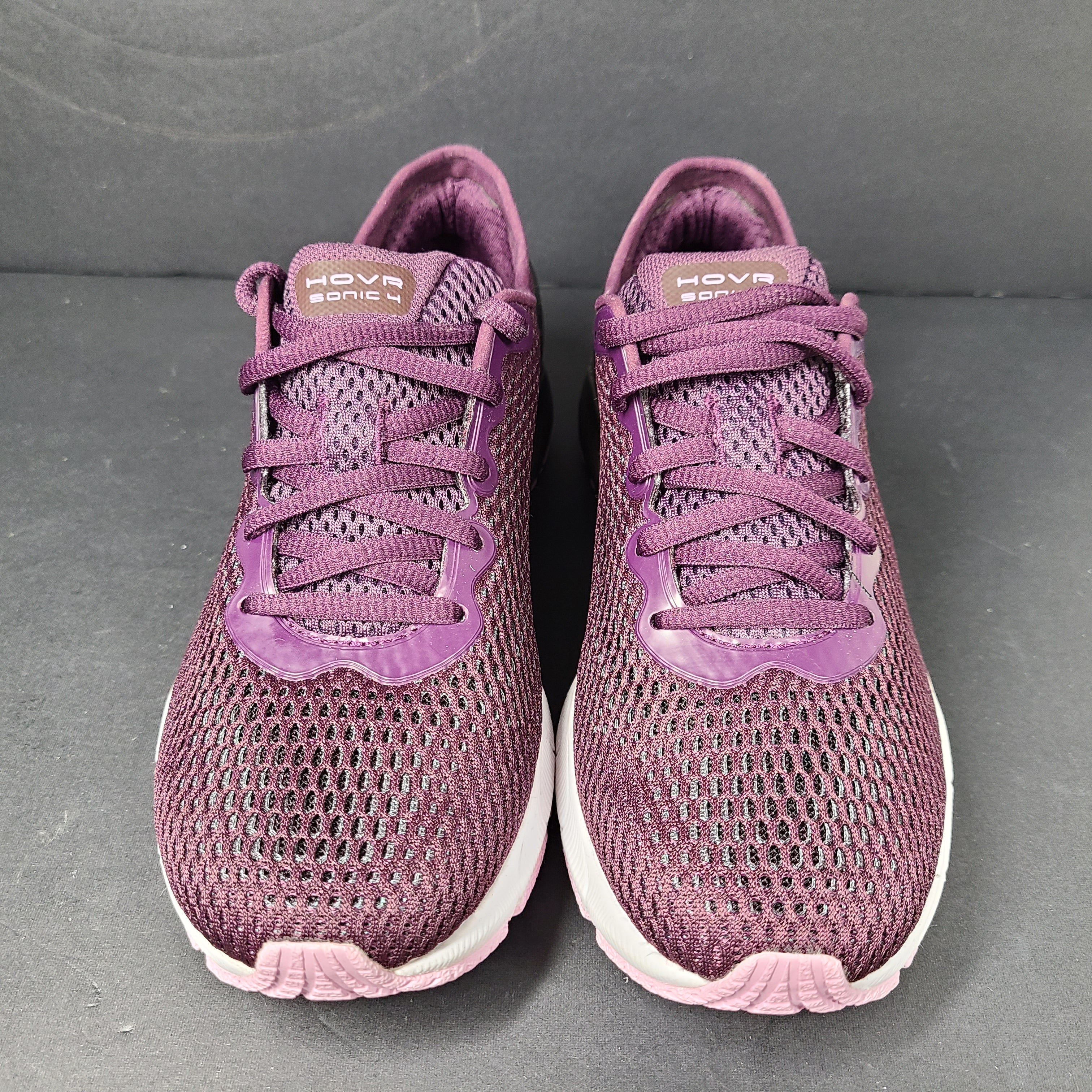 A pair of purple Under Armour HOVR Sonic 4 running shoes for women size 5.