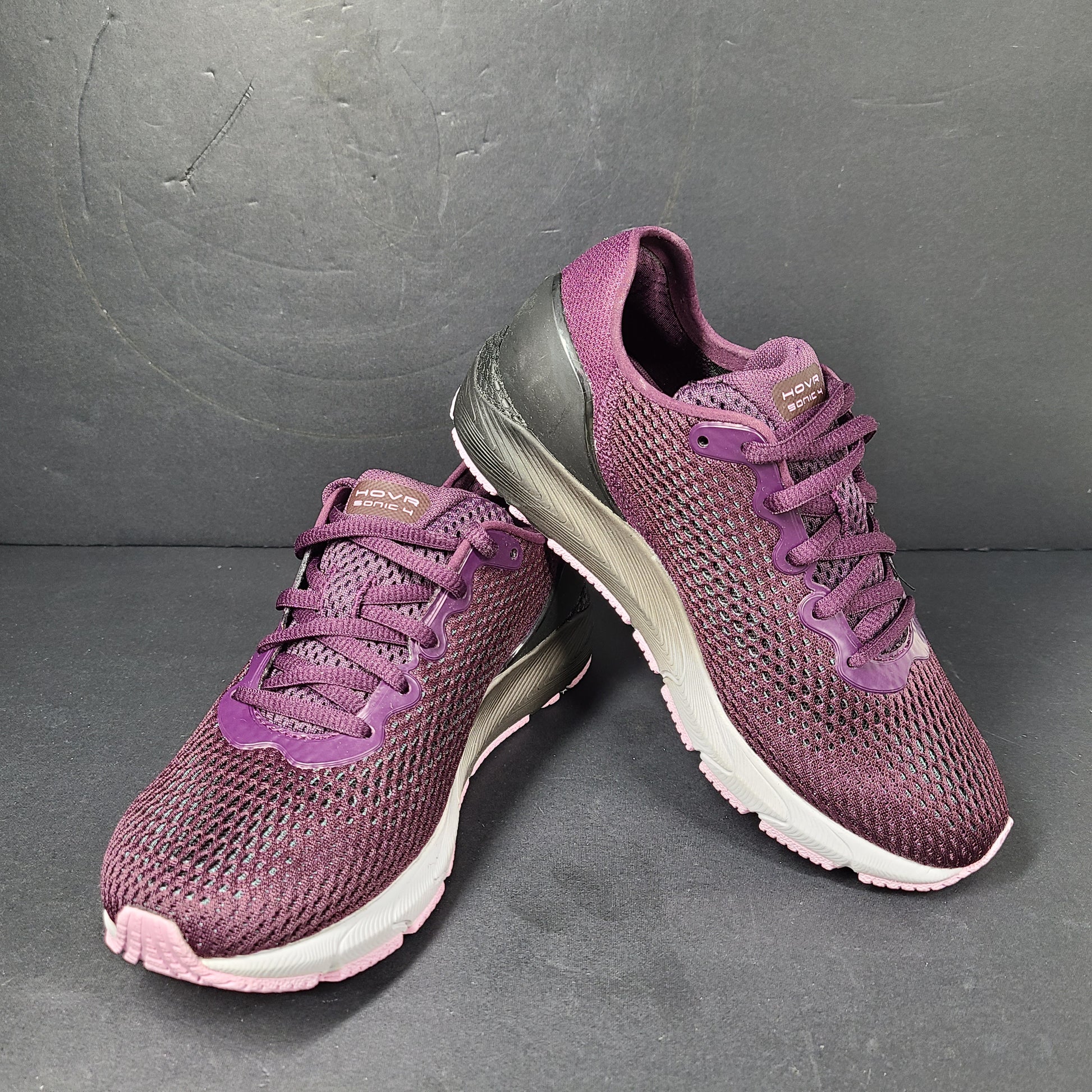 A pair of purple Under Armour HOVR Sonic 4 running shoes for women size 5.