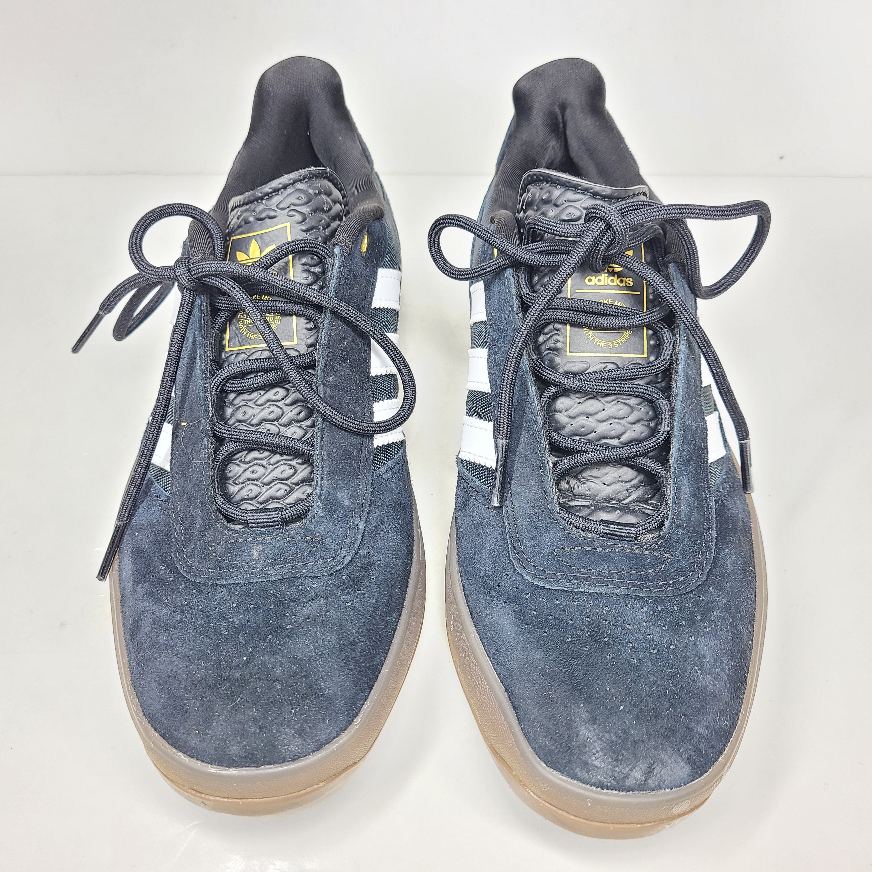 A pair of black Adidas Originals sneakers with model number FV5932.