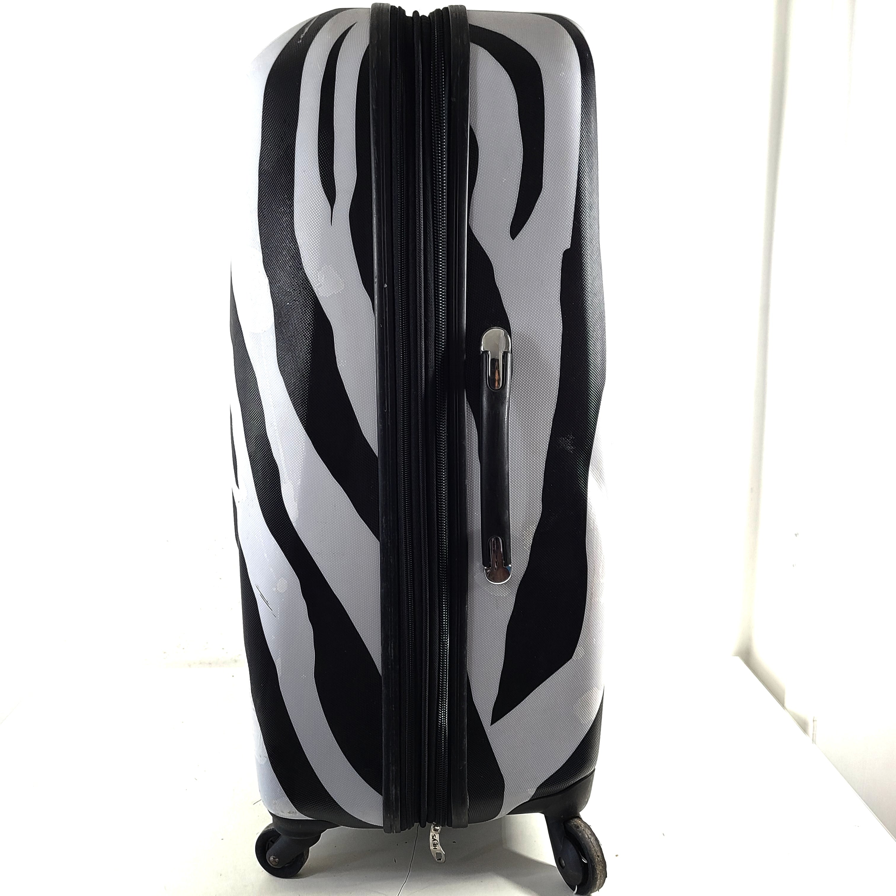 A stylish zebra-print hard shell luggage by Heys
