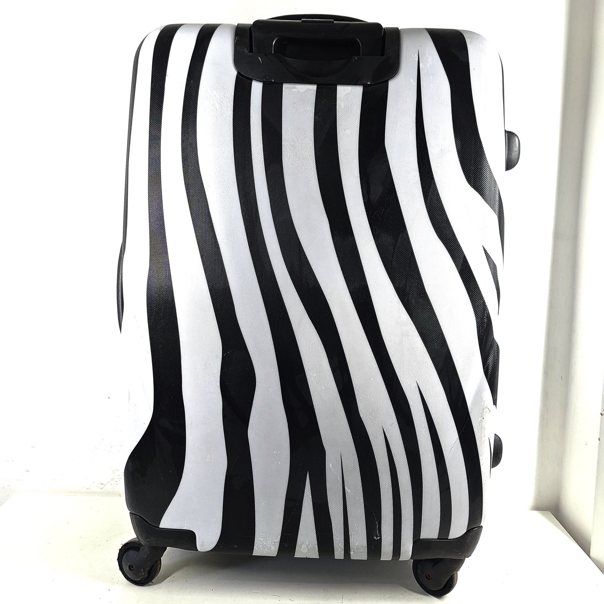 A stylish zebra-print hard shell luggage by Heys