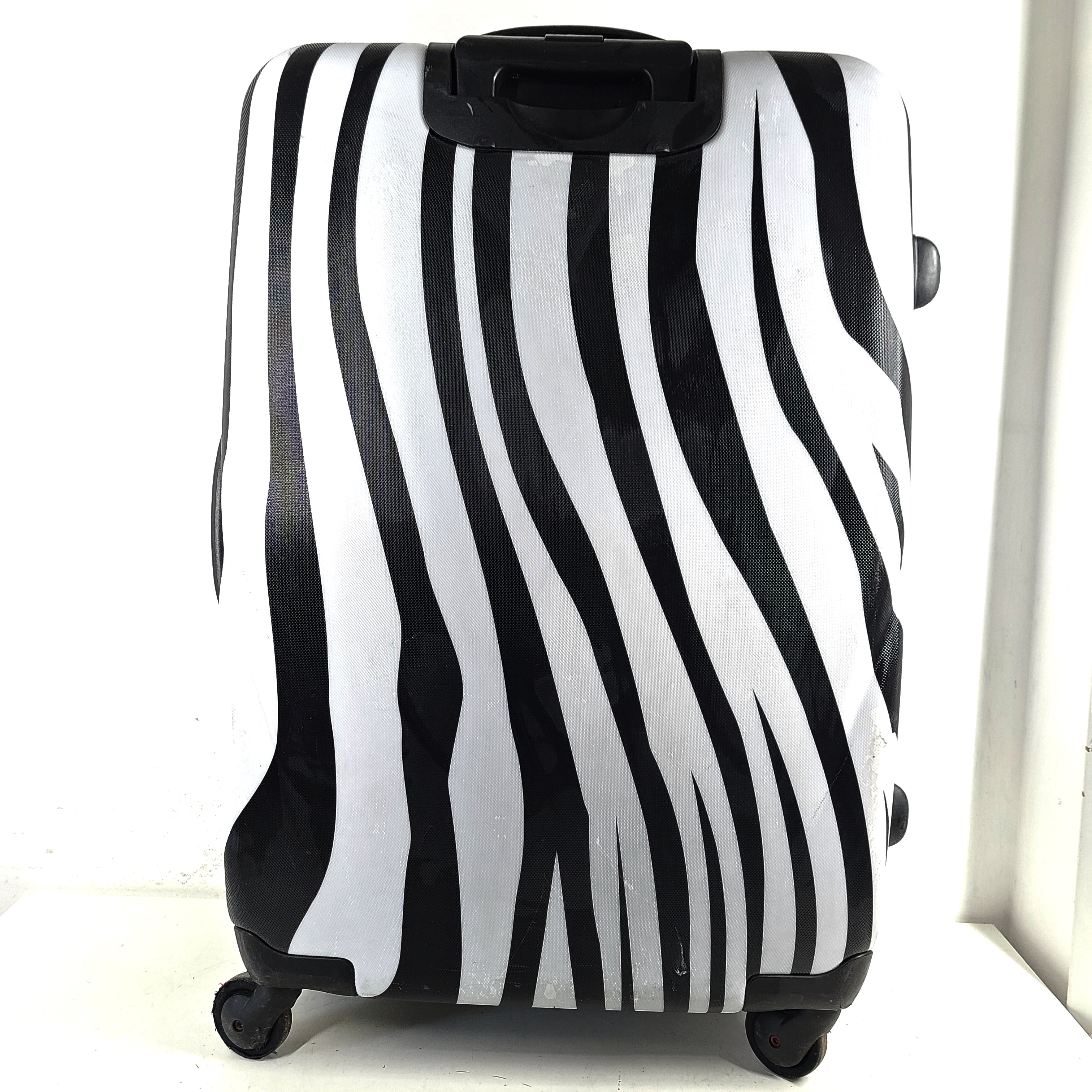 A stylish zebra-print hard shell luggage by Heys