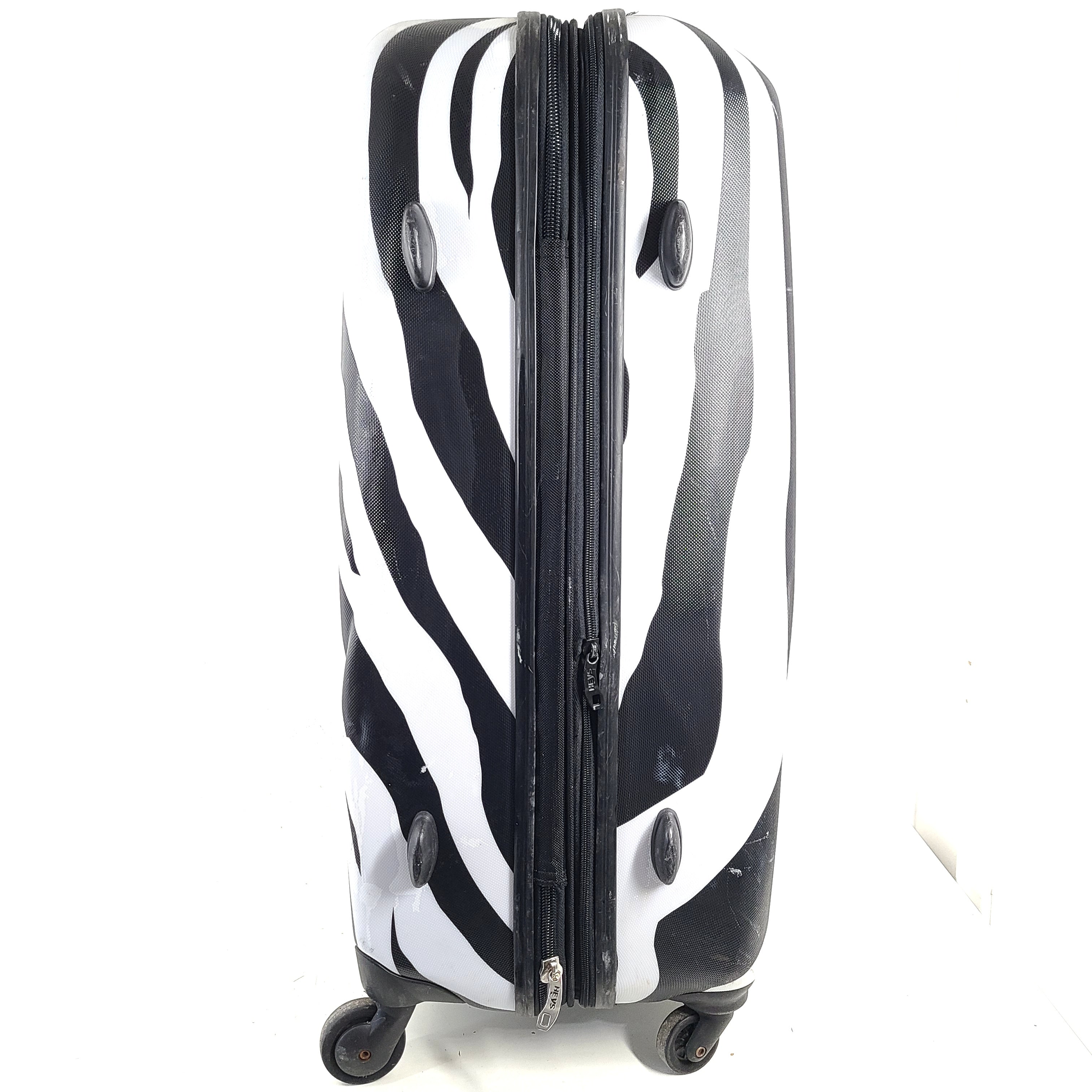 A stylish zebra-print hard shell luggage by Heys