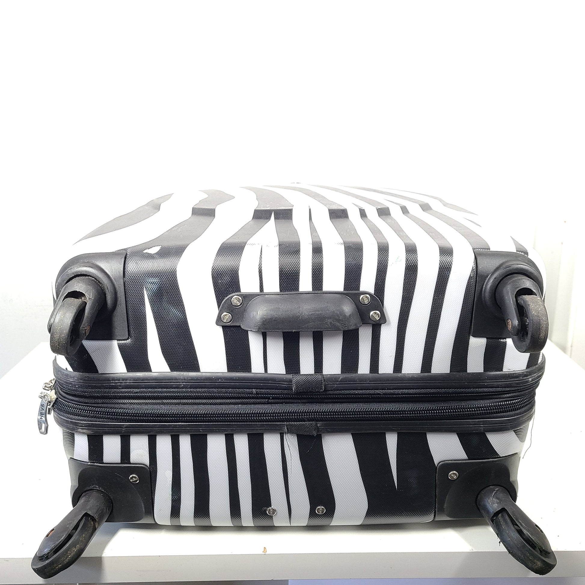 A stylish zebra-print hard shell luggage by Heys