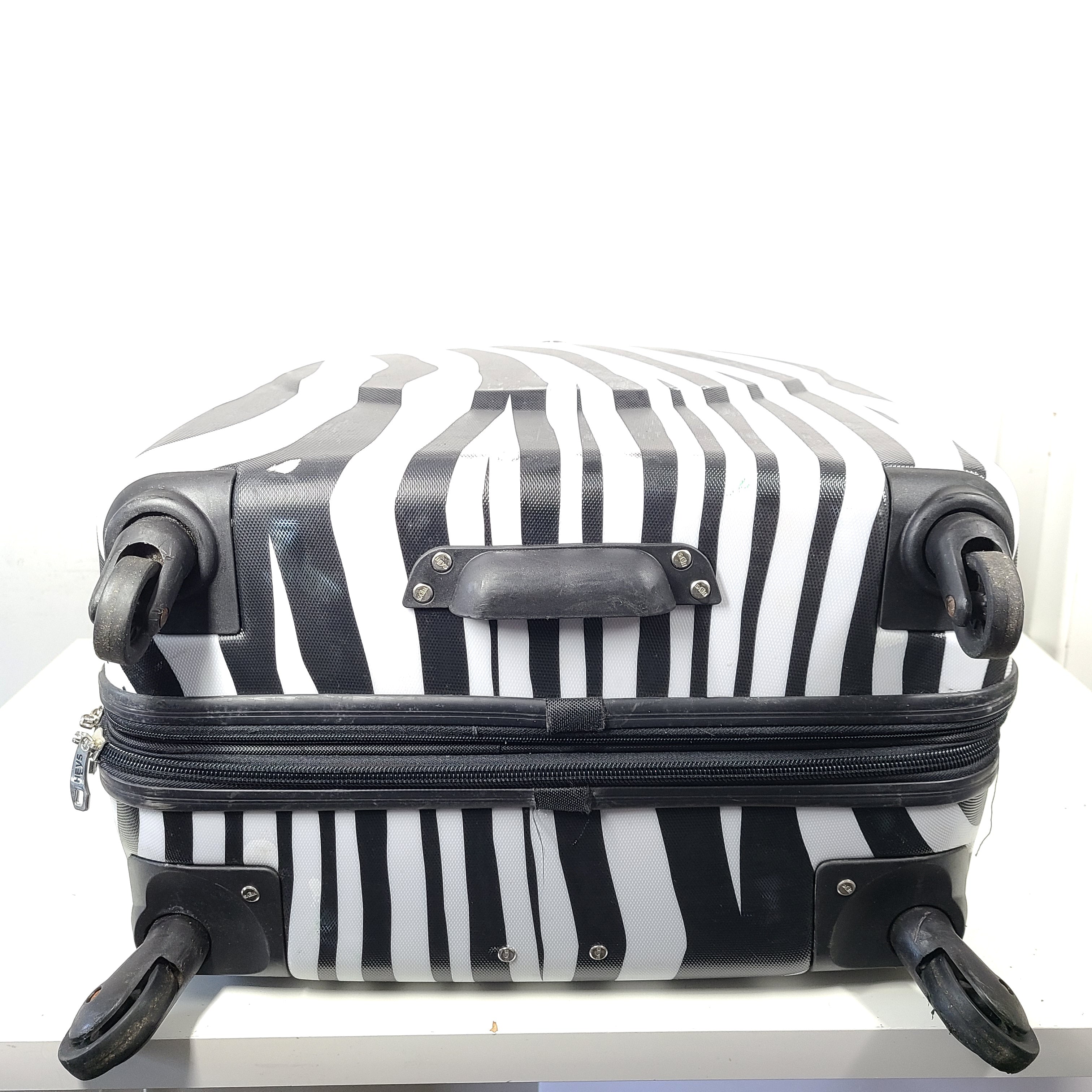 A stylish zebra-print hard shell luggage by Heys