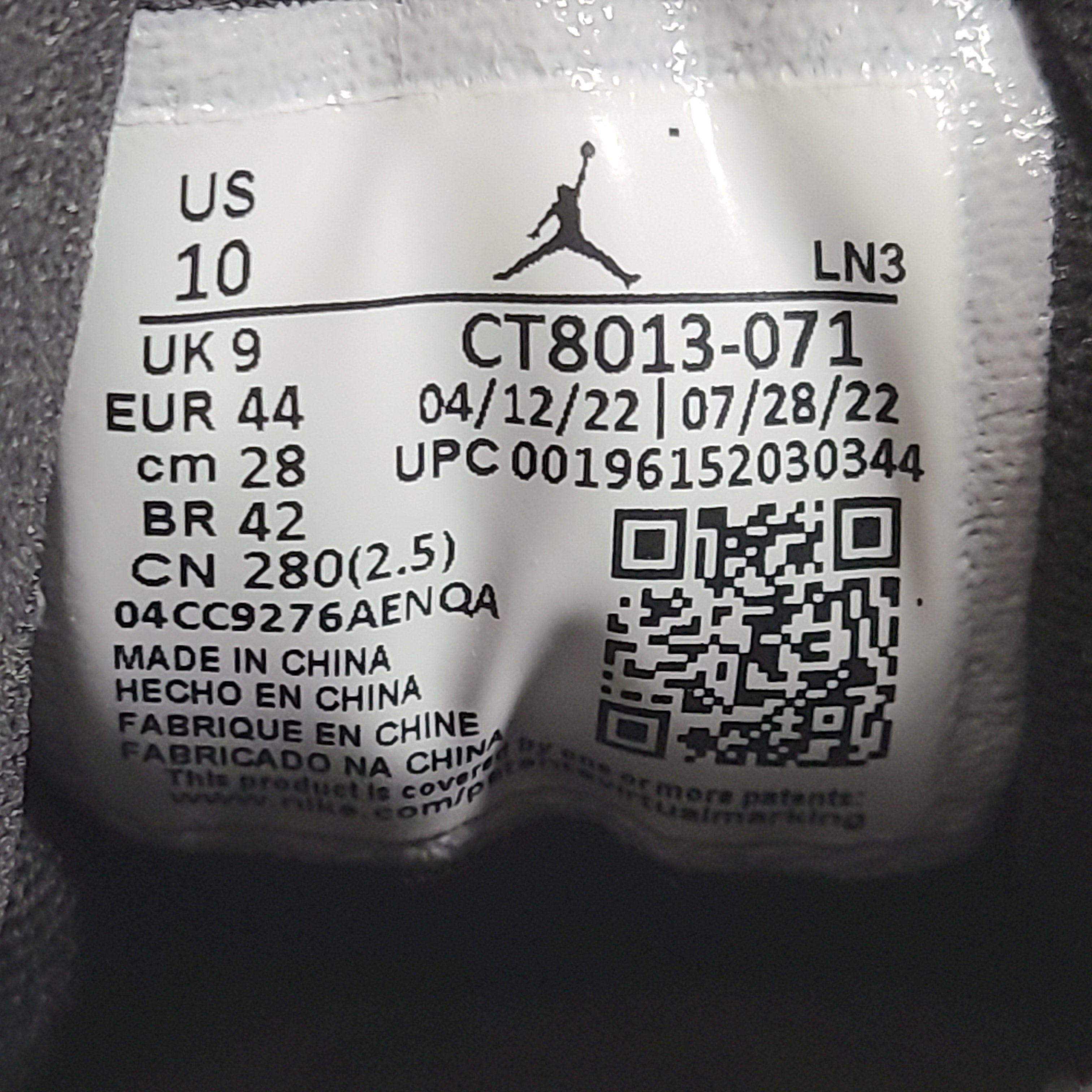 A pair of black and yellow Nike Air Jordan 12 Retro sneakers