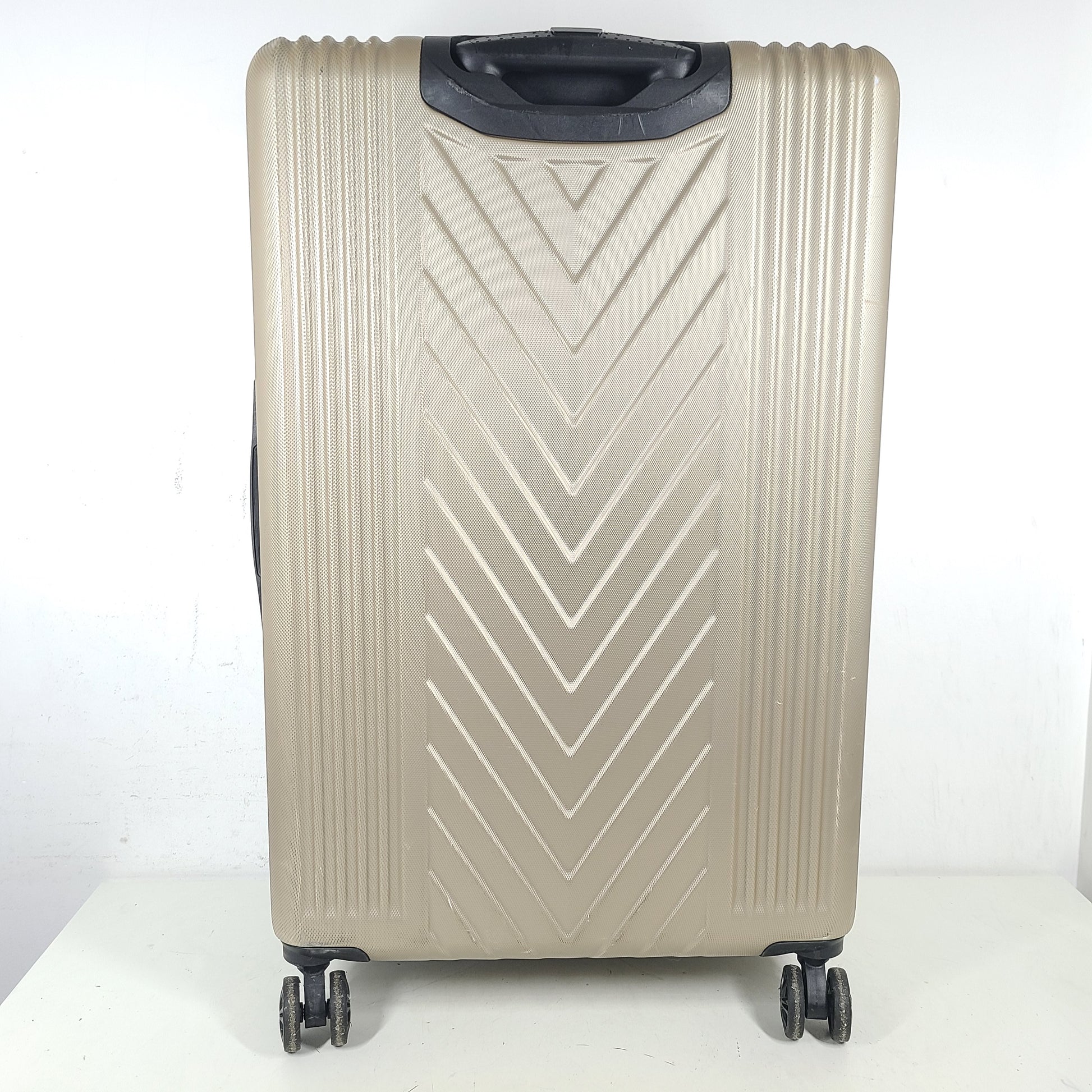 A stylish gold BCBGeneration suitcase made of 100% ABS material.