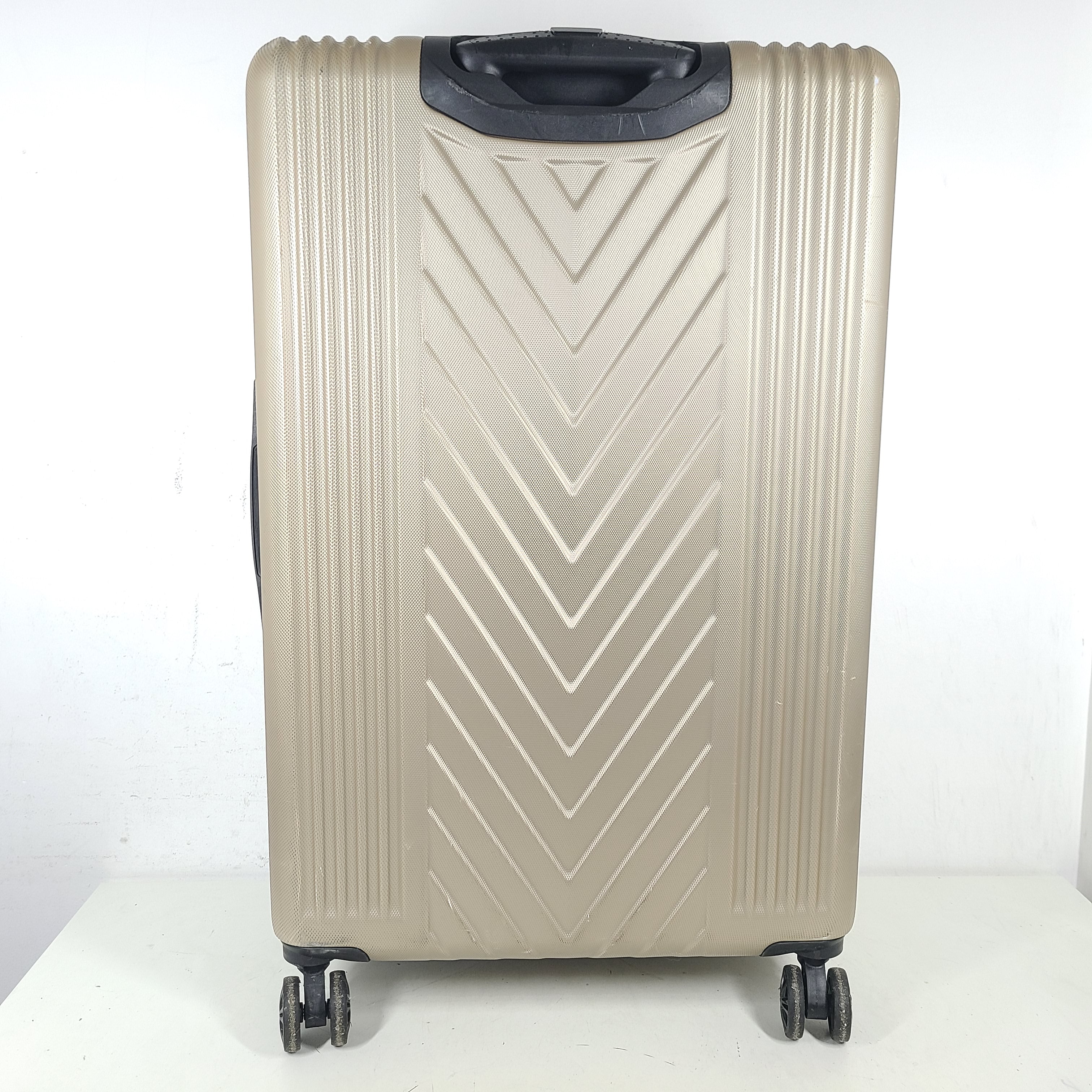A stylish gold BCBGeneration suitcase made of 100% ABS material.