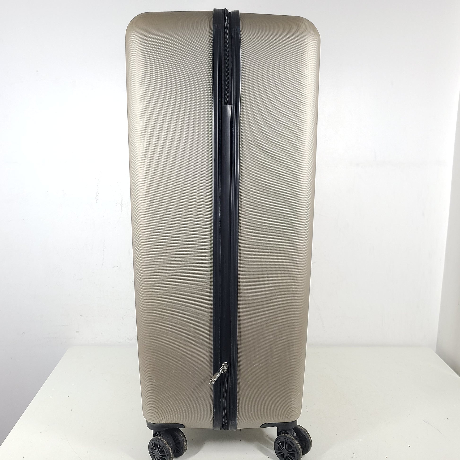 A stylish gold BCBGeneration suitcase made of 100% ABS material.