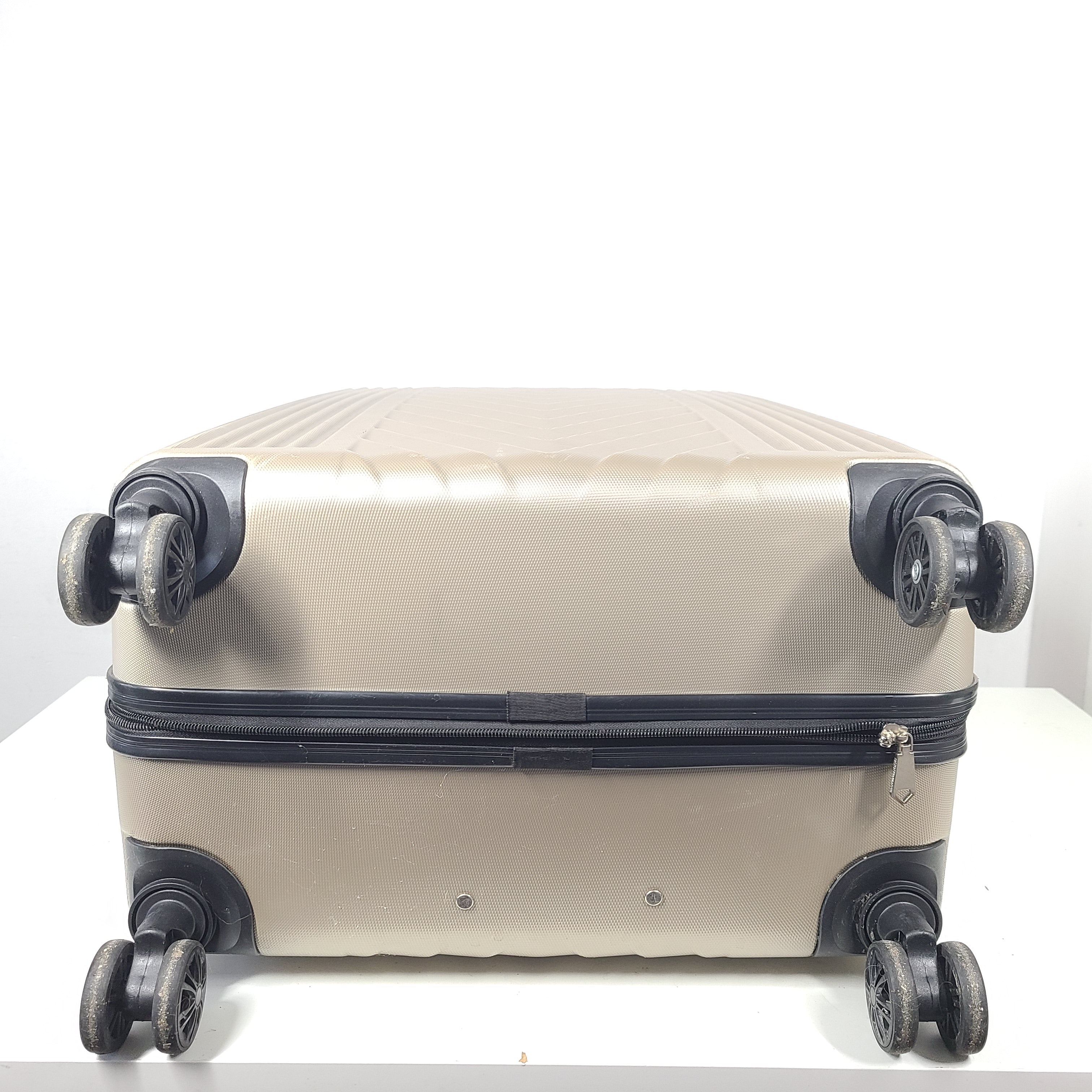 A stylish gold BCBGeneration suitcase made of 100% ABS material.