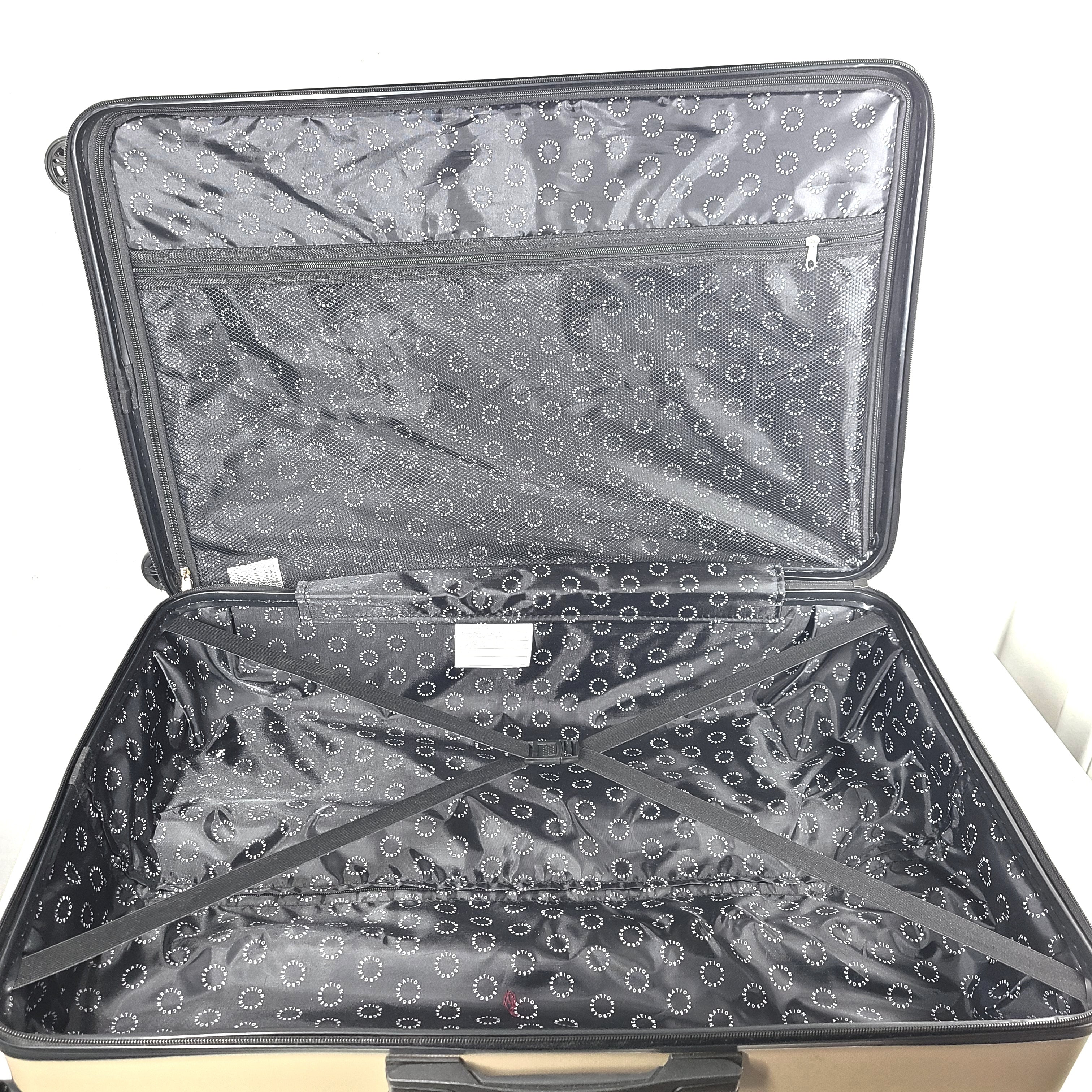 A stylish gold BCBGeneration suitcase made of 100% ABS material.