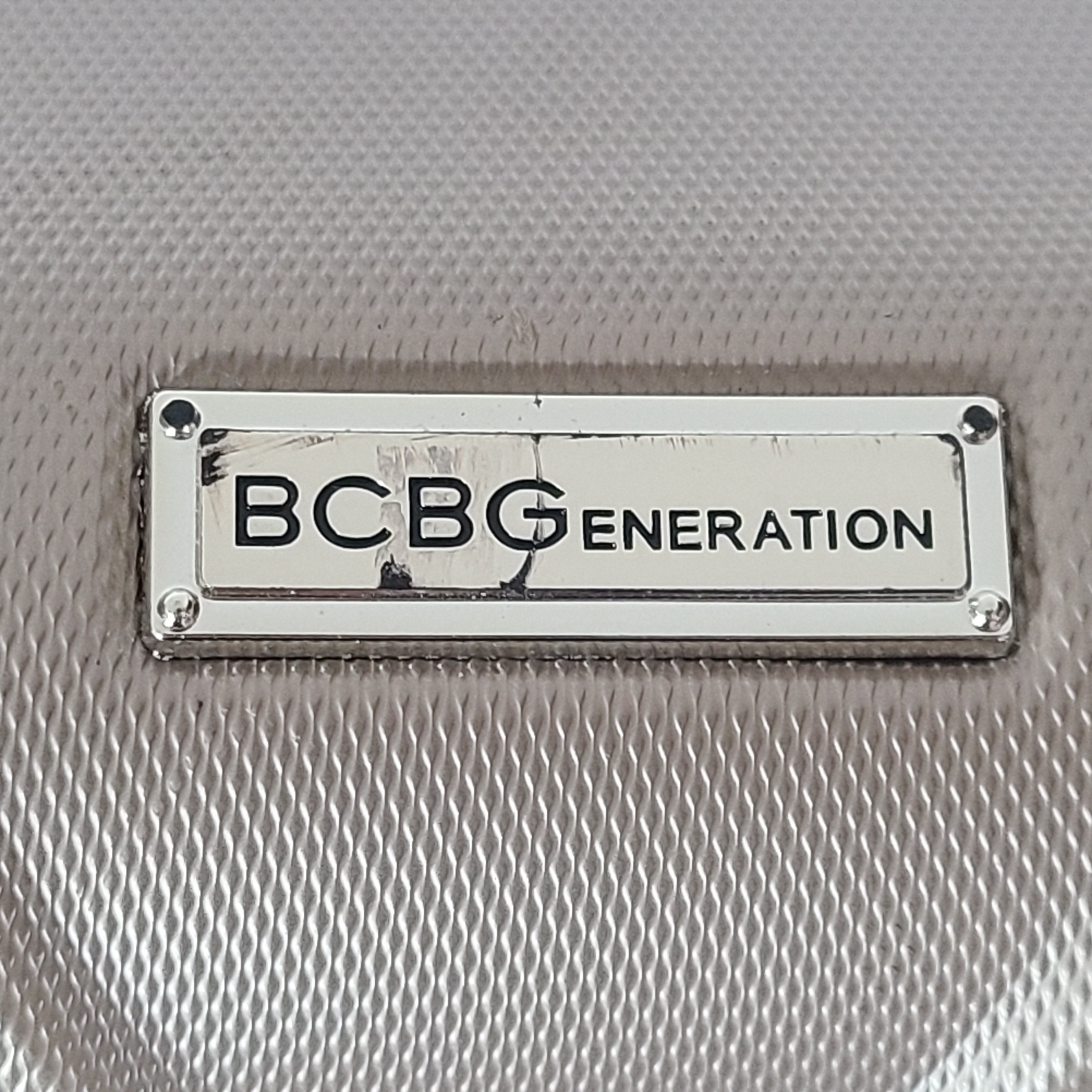 A stylish gold BCBGeneration suitcase made of 100% ABS material.