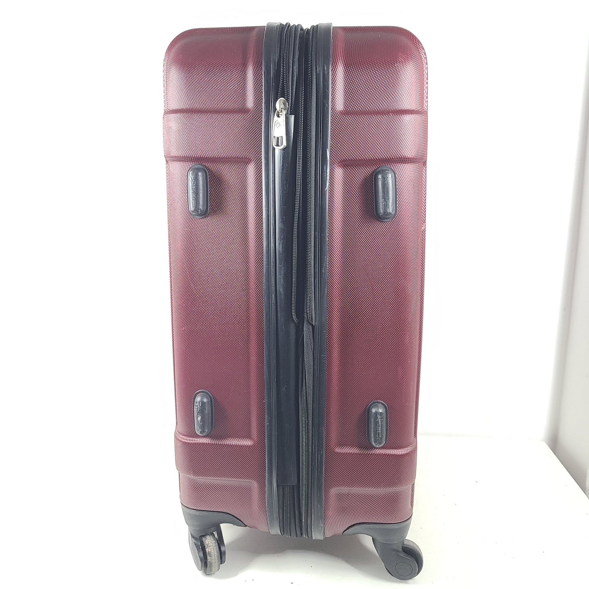 A burgundy Samsonite hardside spinner suitcase
