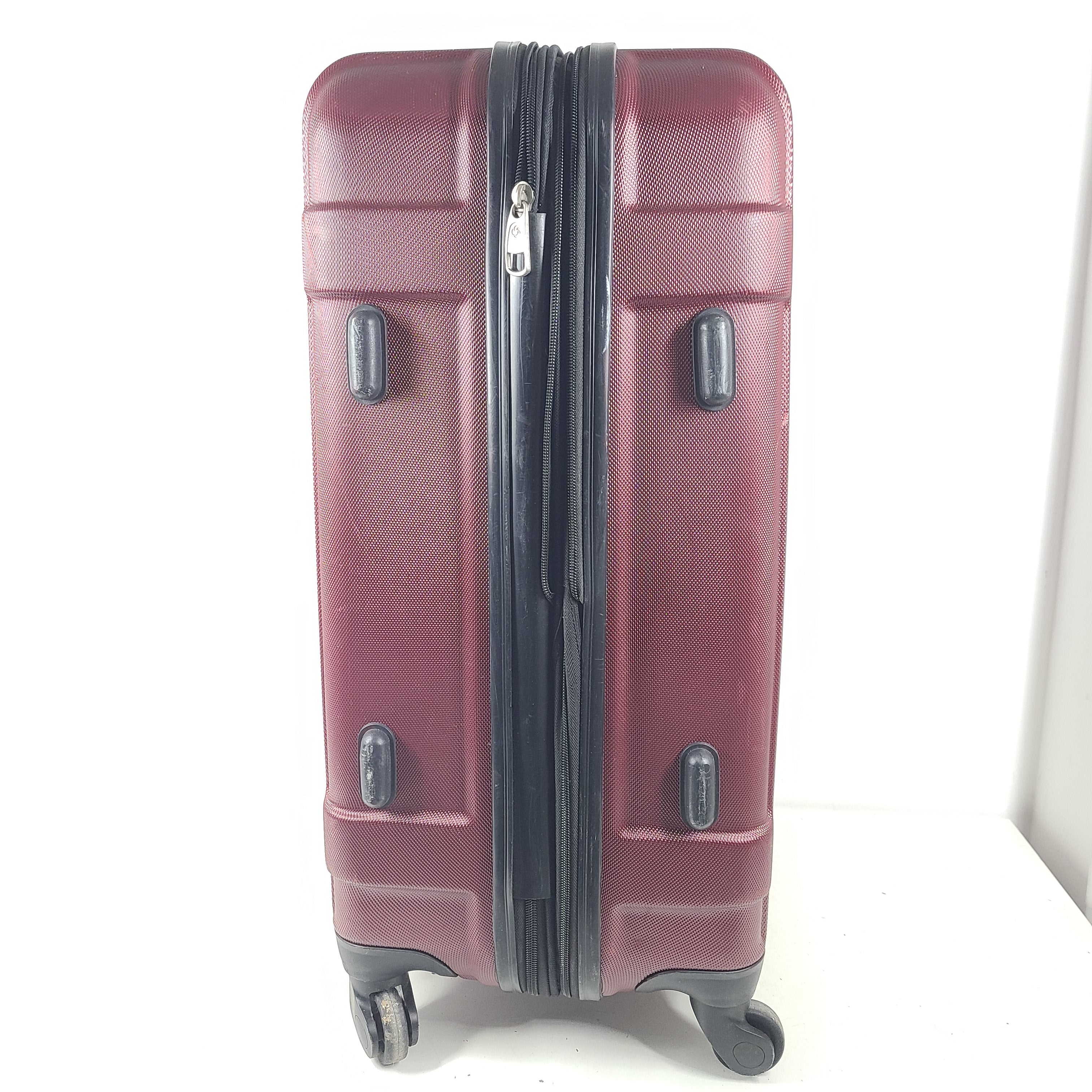 A burgundy Samsonite hardside spinner suitcase