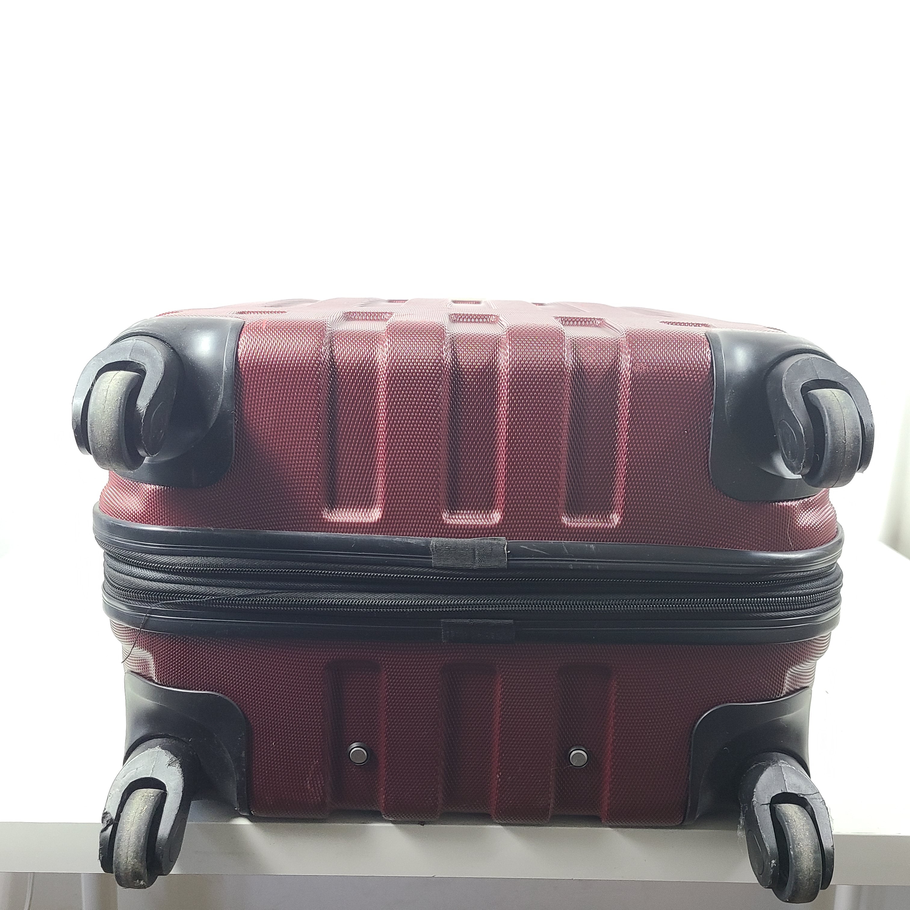 A burgundy Samsonite hardside spinner suitcase