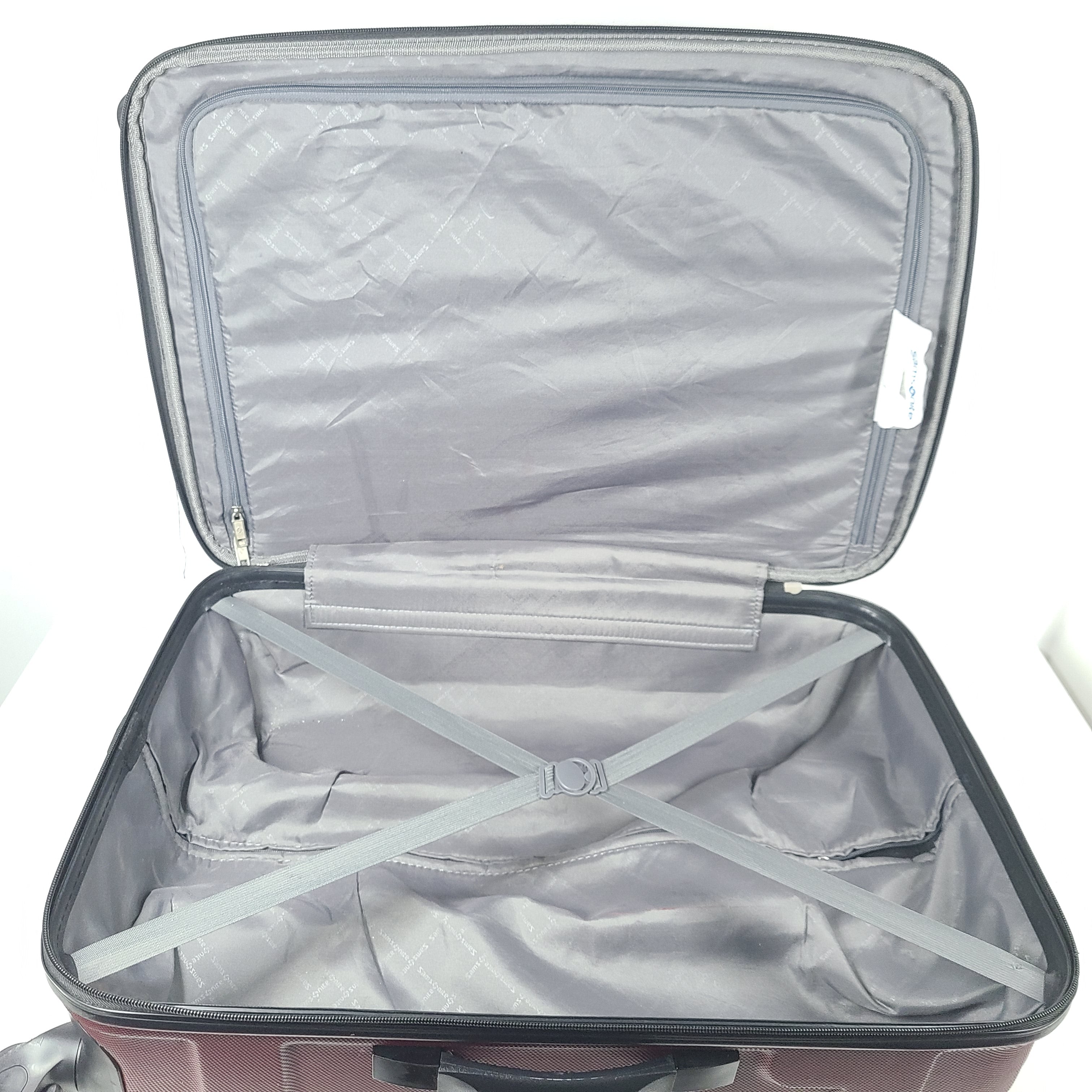A burgundy Samsonite hardside spinner suitcase