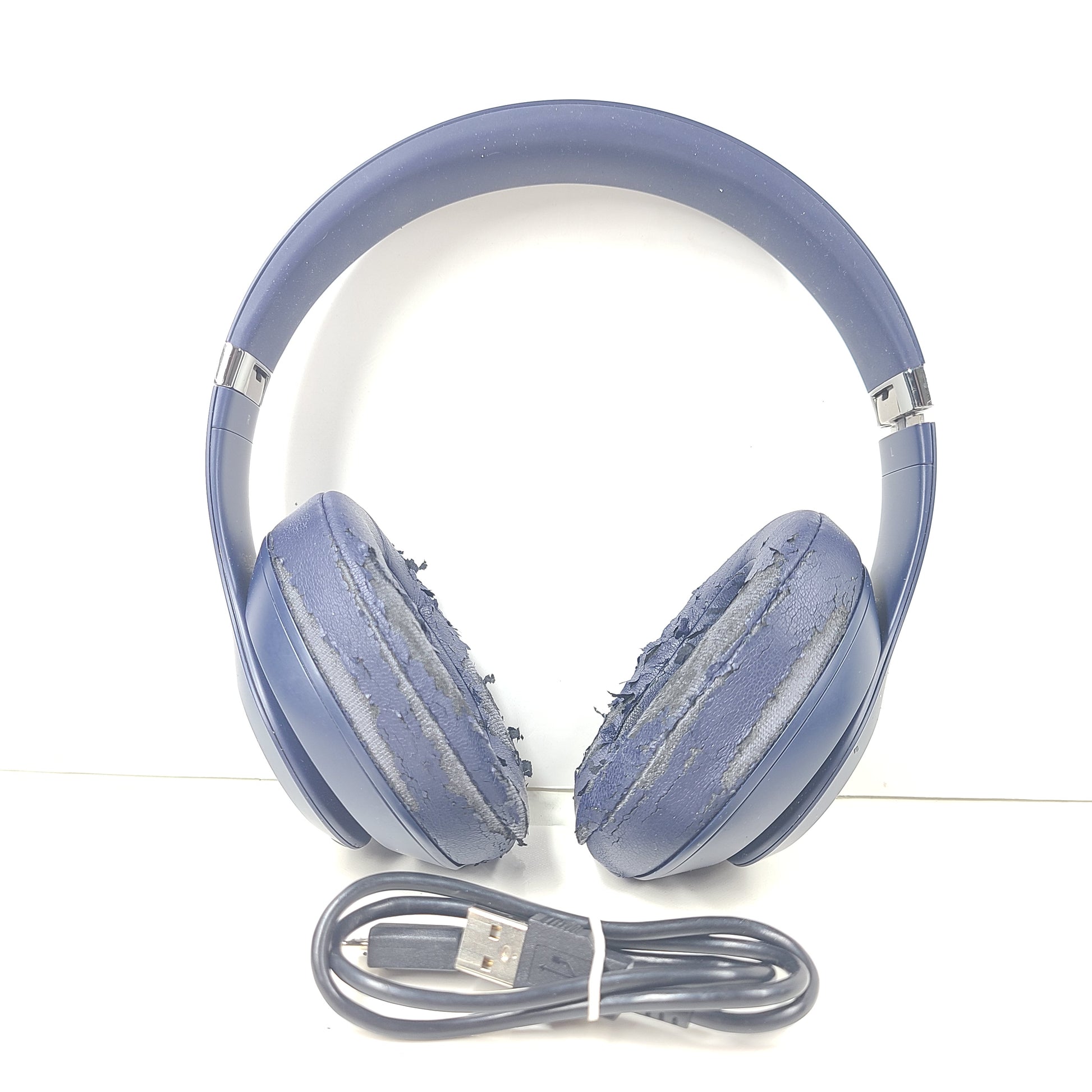A pair of blue Beats wireless headphones.