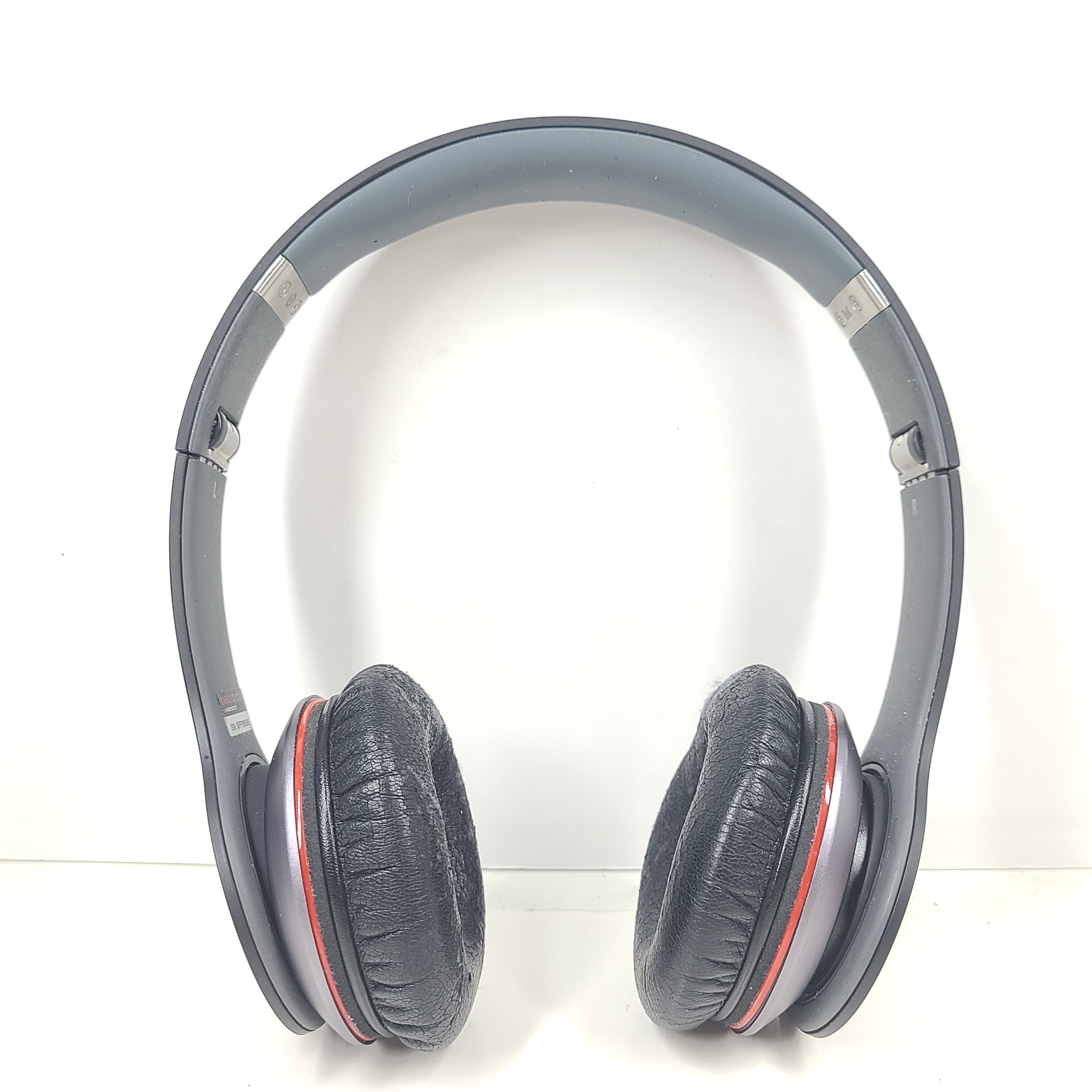 A pair of black and red Beats by Dr. Dre Solo HD Wired Headphones with case