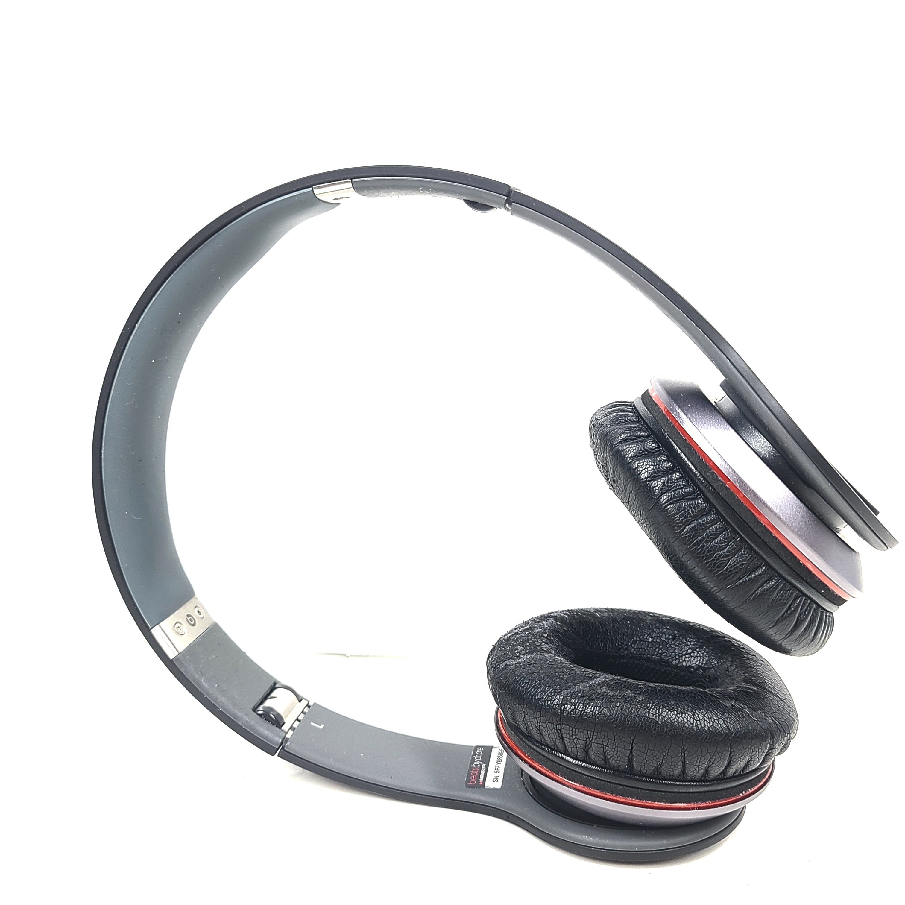 A pair of black and red Beats by Dr. Dre Solo HD Wired Headphones with case