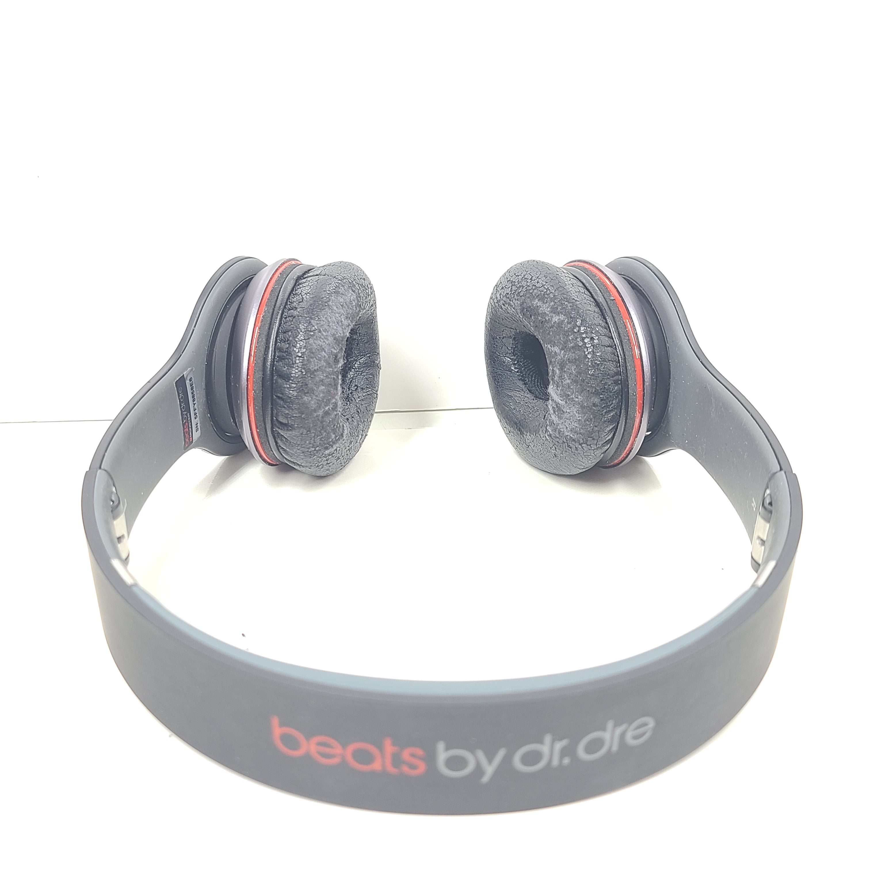 A pair of black and red Beats by Dr. Dre Solo HD Wired Headphones with case