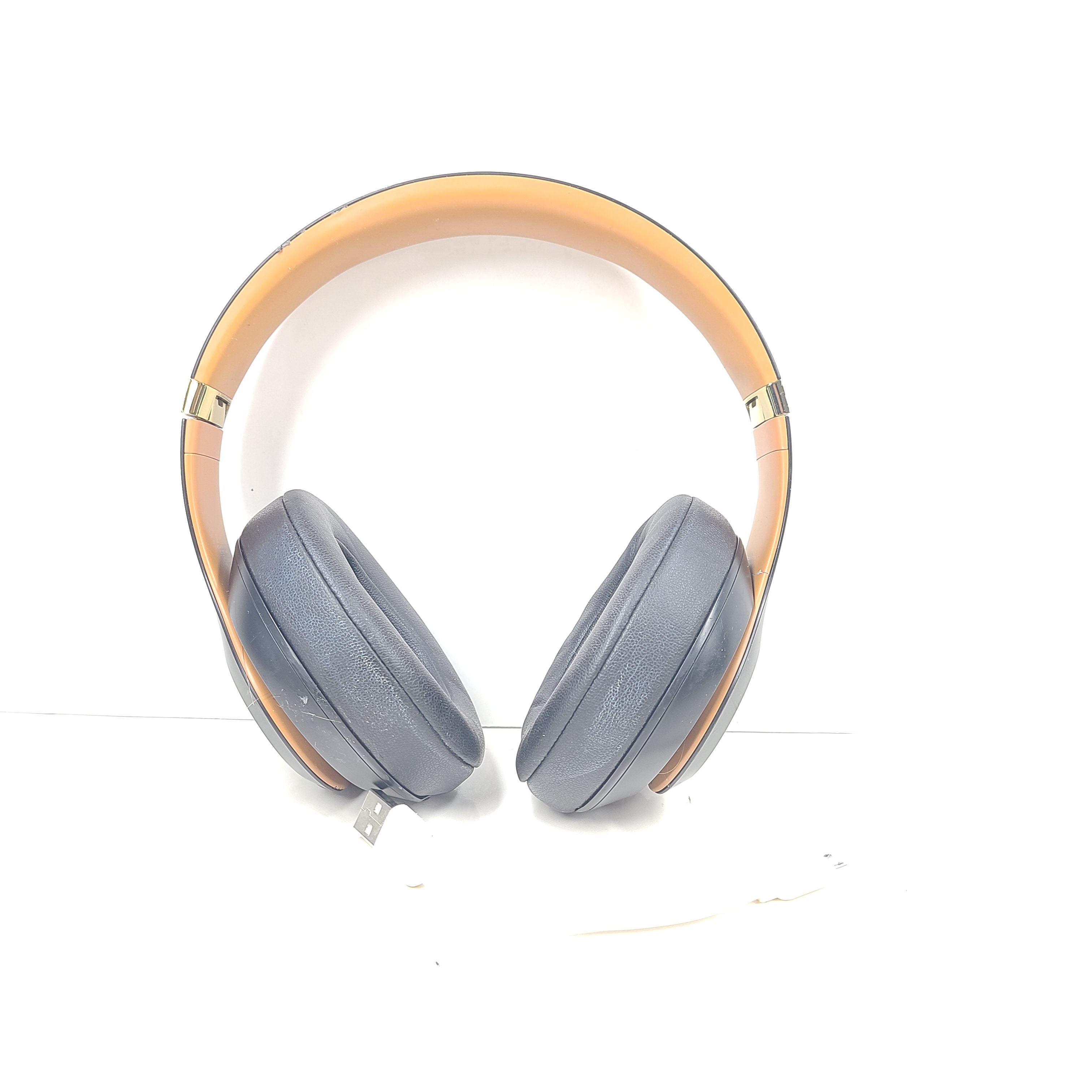A pair of black and gold Beats Wireless Over-Ear Headphones