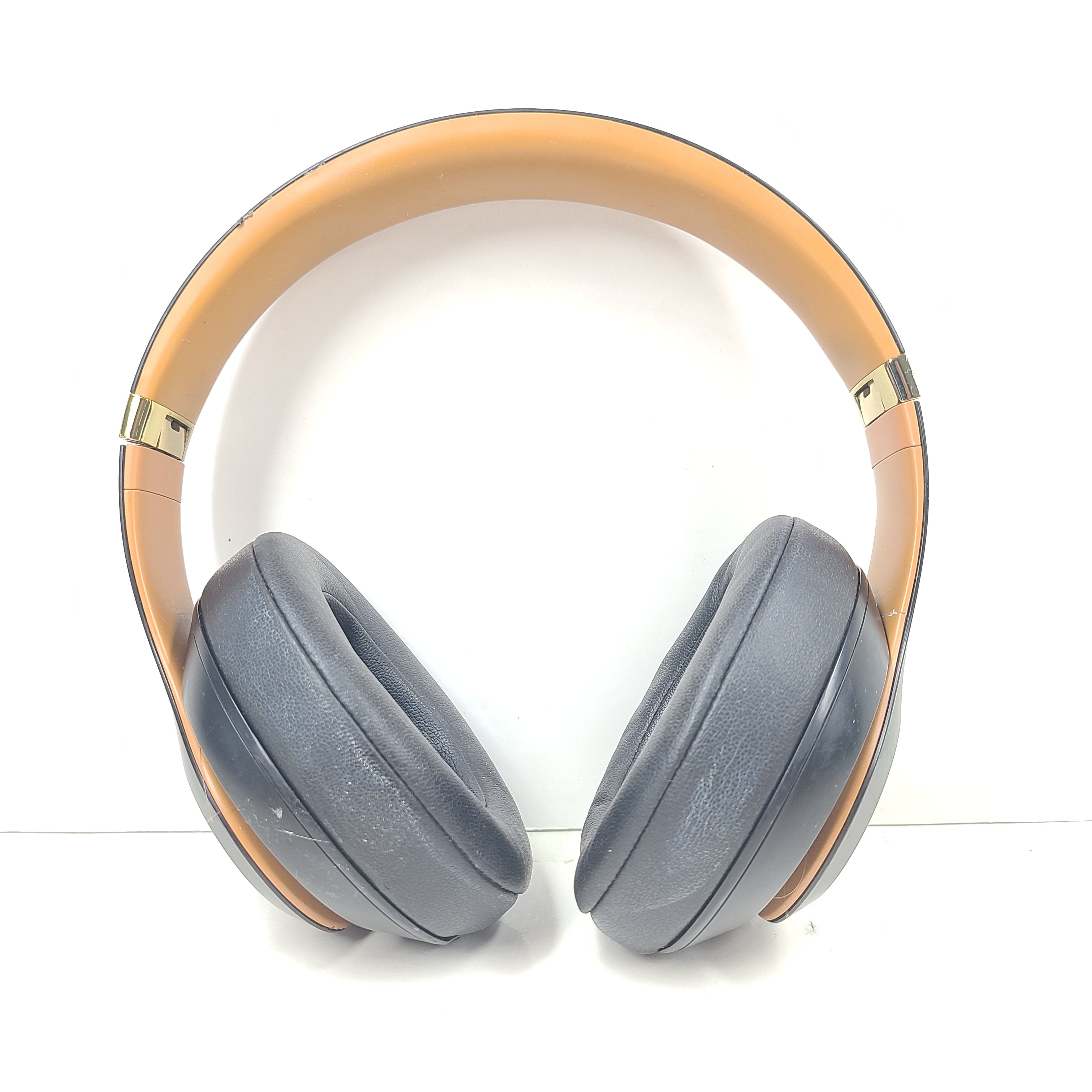 A pair of black and gold Beats Wireless Over-Ear Headphones