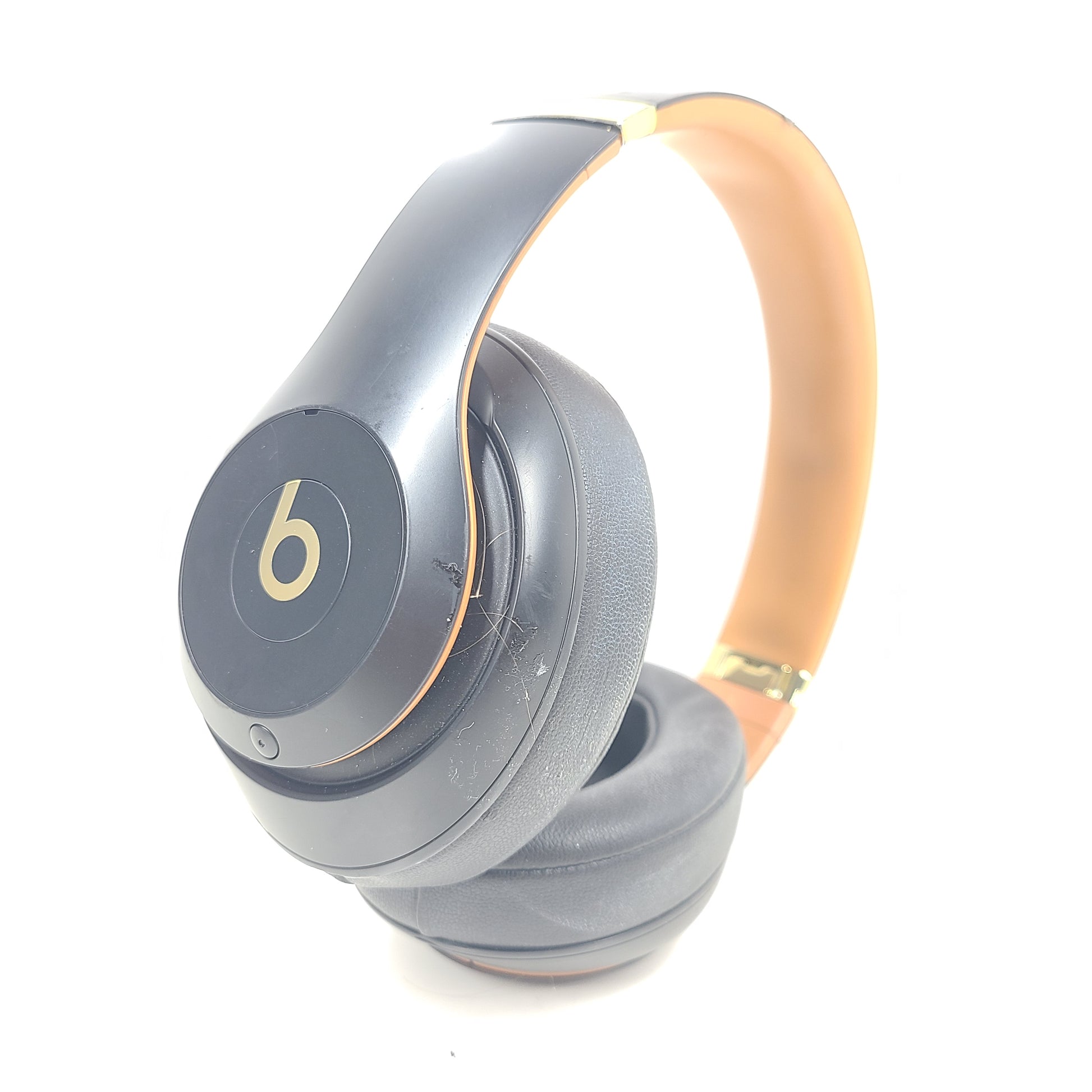 A pair of black and gold Beats Wireless Over-Ear Headphones
