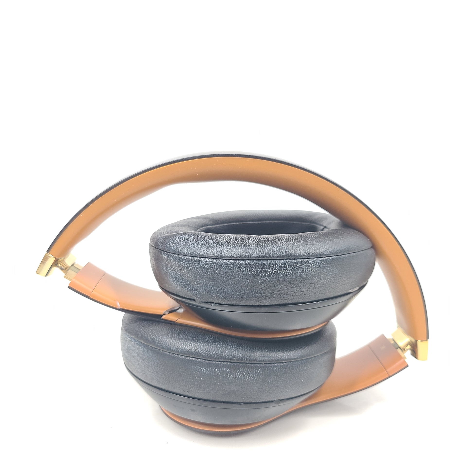 A pair of black and gold Beats Wireless Over-Ear Headphones