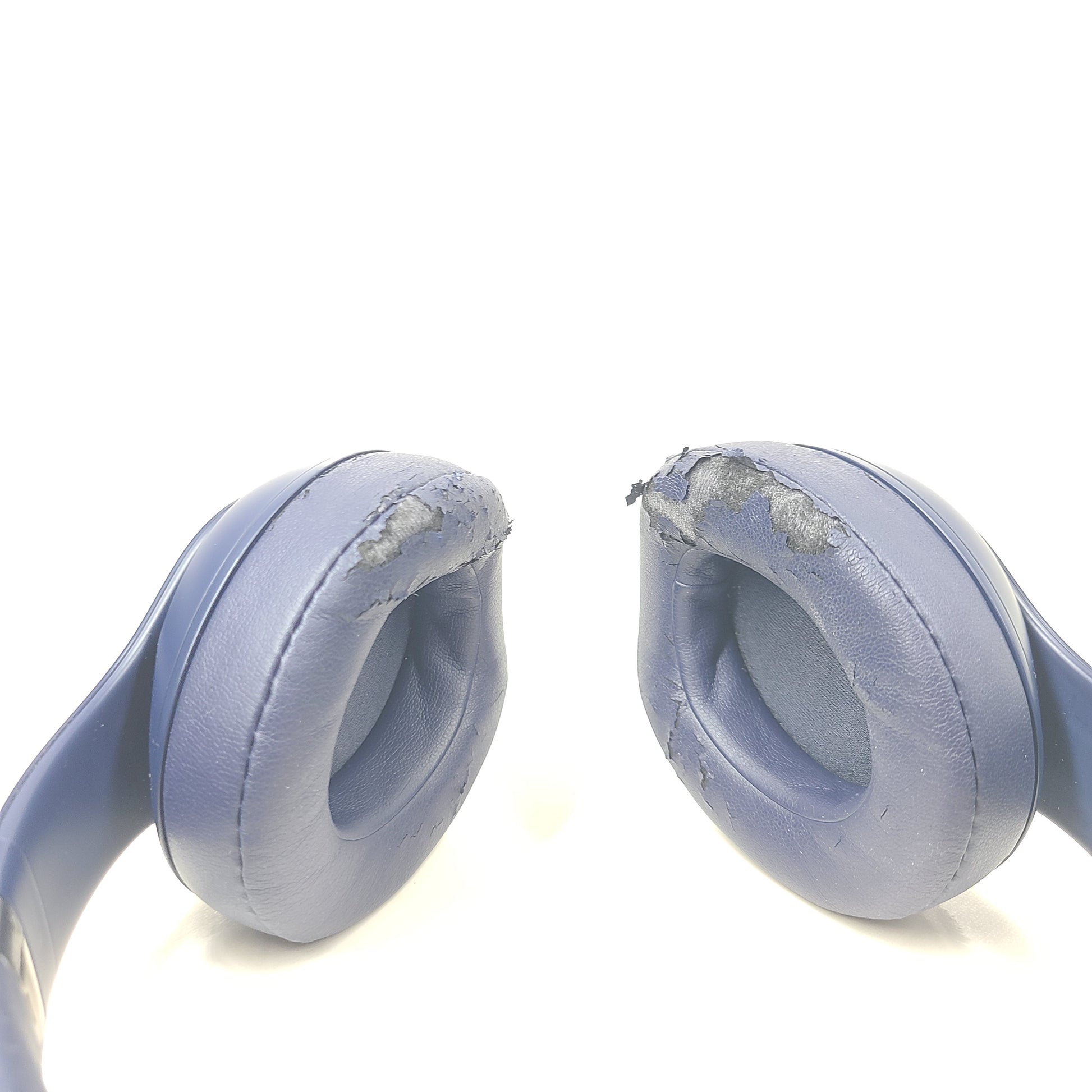 A pair of blue Beats wireless over-ear headphones.