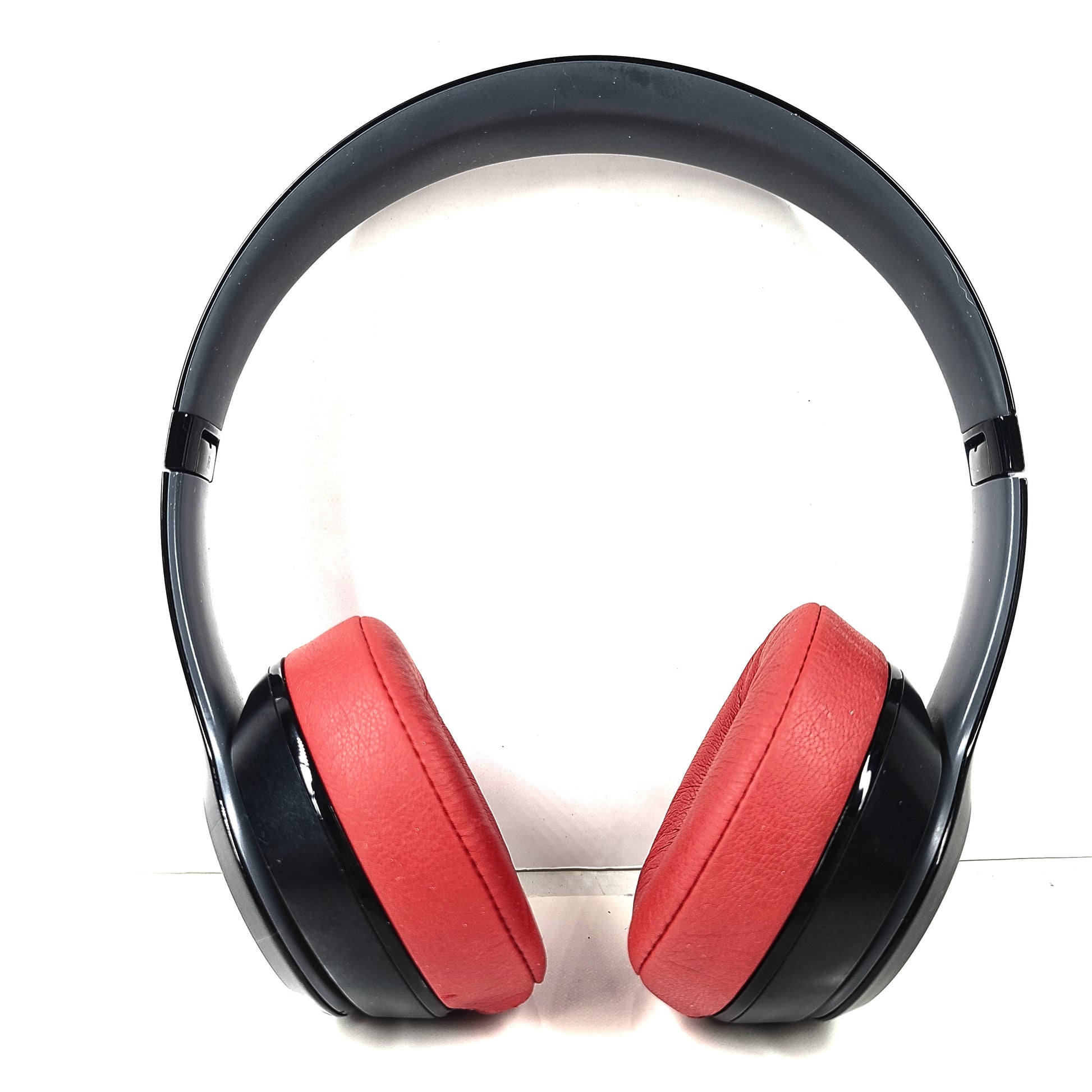 A pair of Beats Solo Wireless Headphones in red and black design