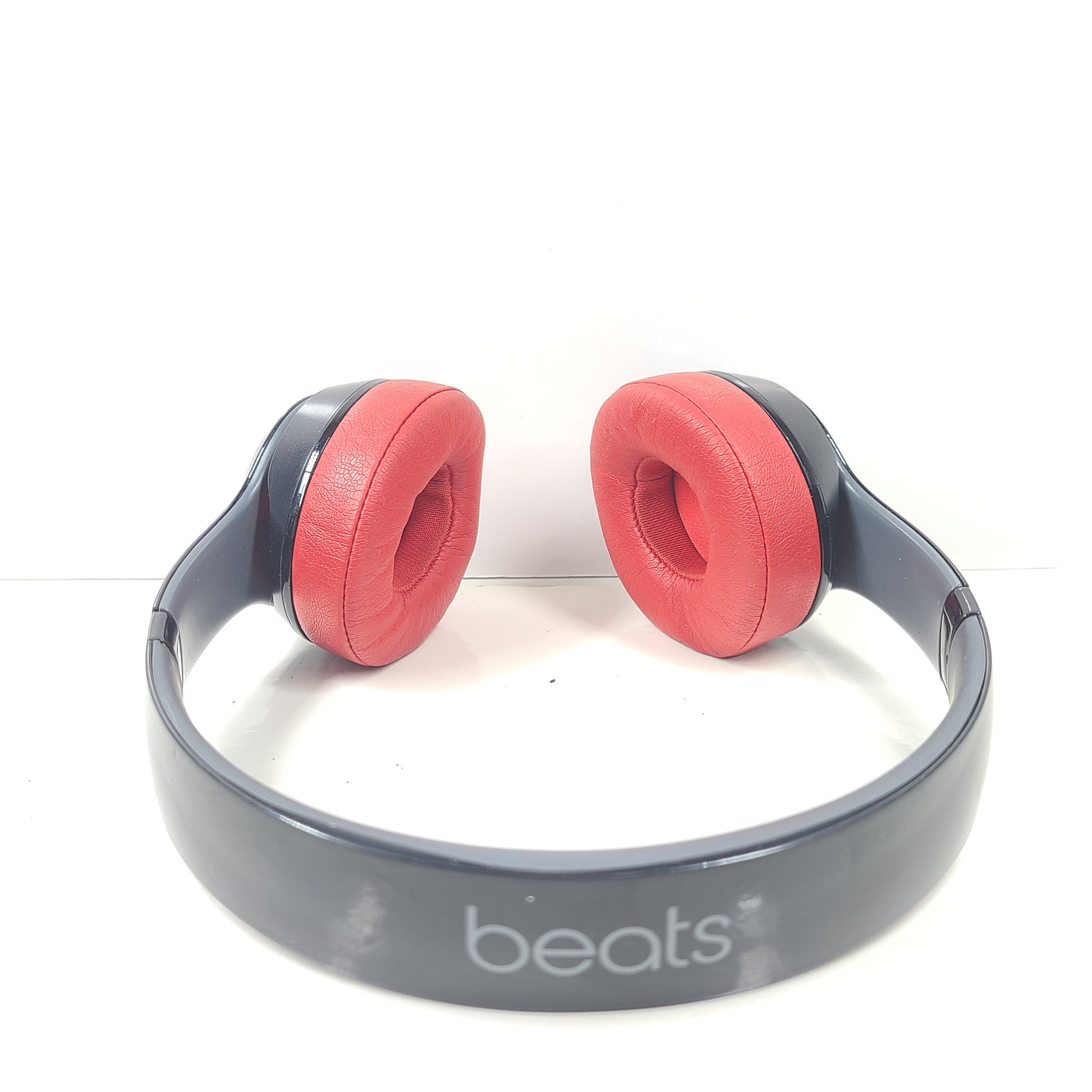 A pair of Beats Solo Wireless Headphones in red and black design
