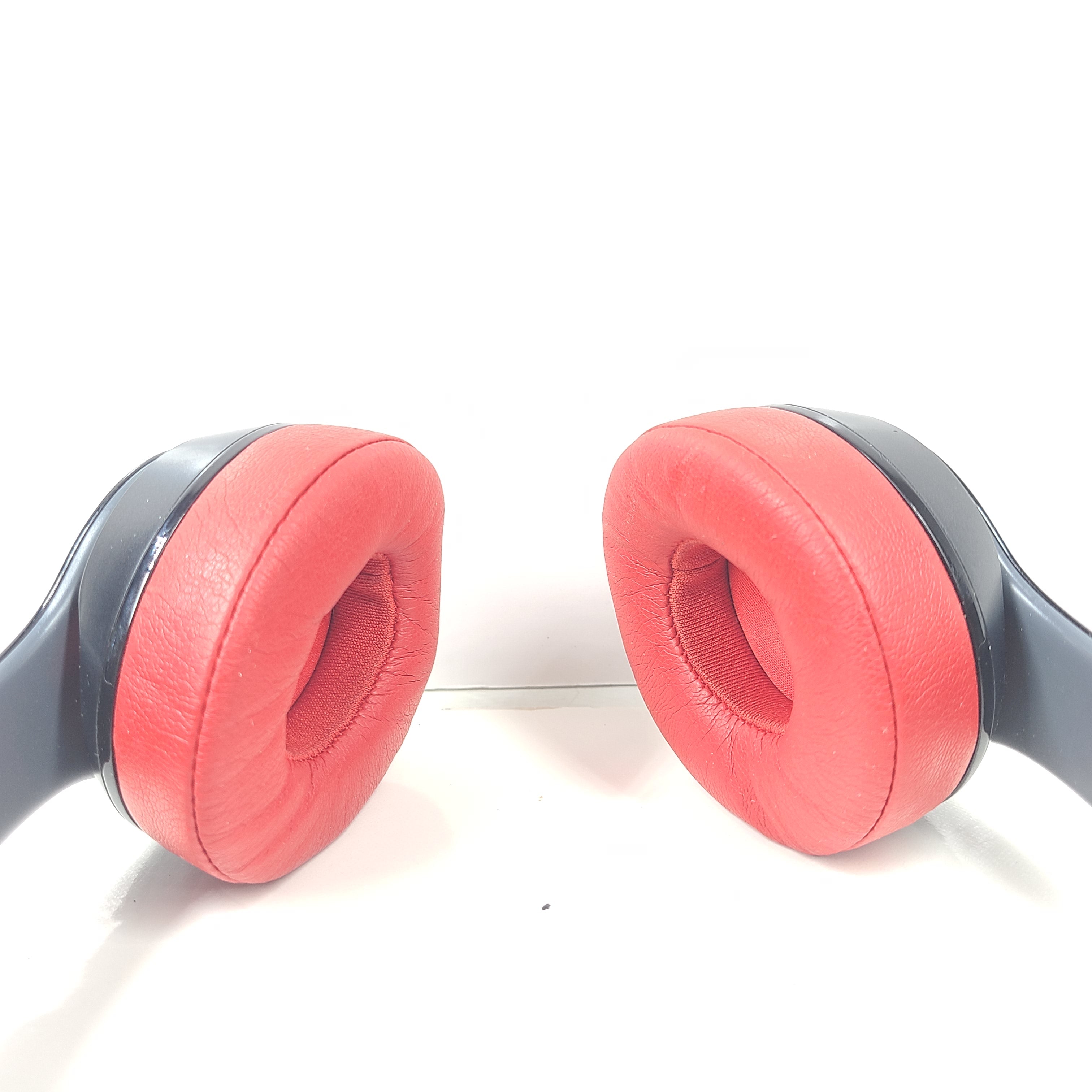 A pair of Beats Solo Wireless Headphones in red and black design