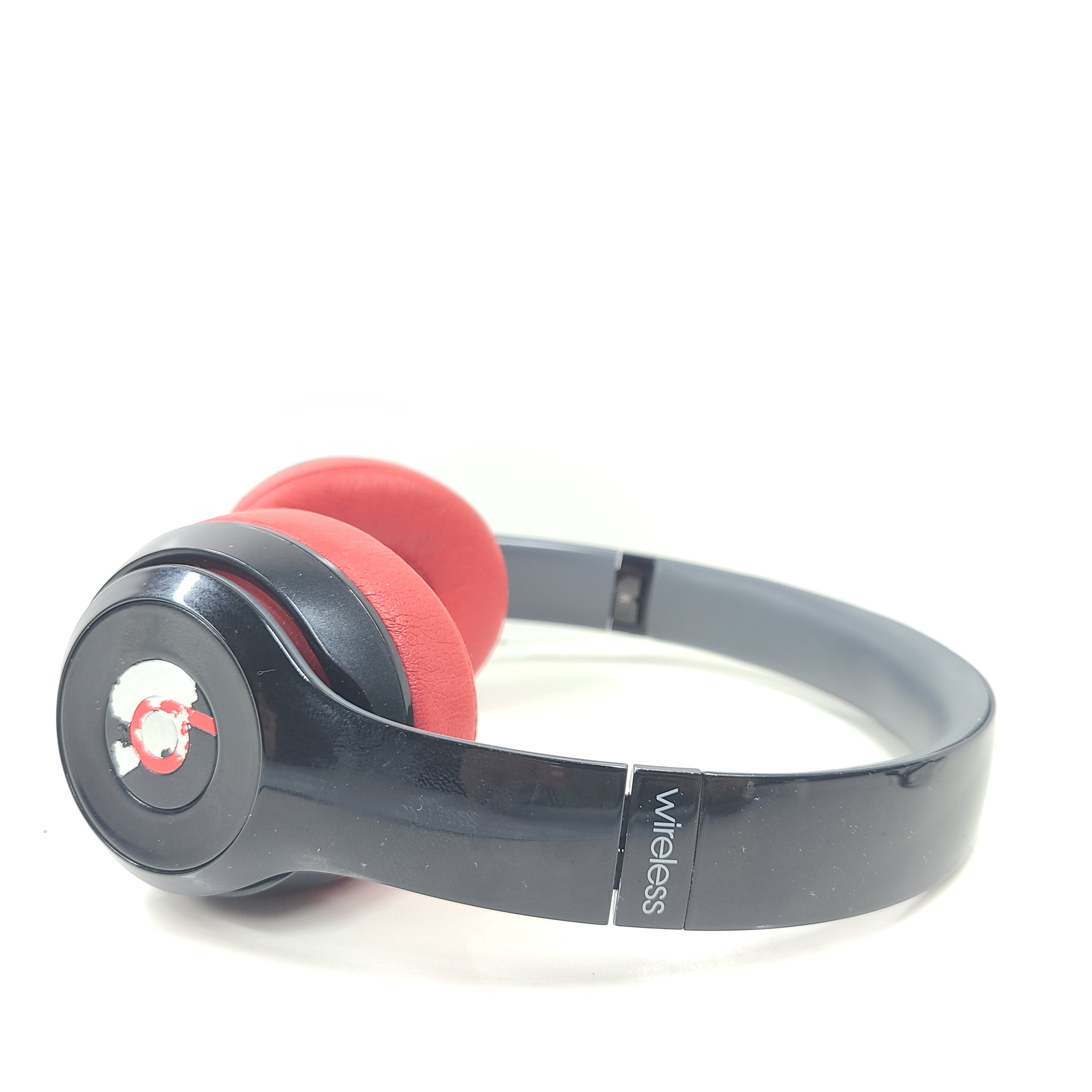 A pair of Beats Solo Wireless Headphones in red and black design